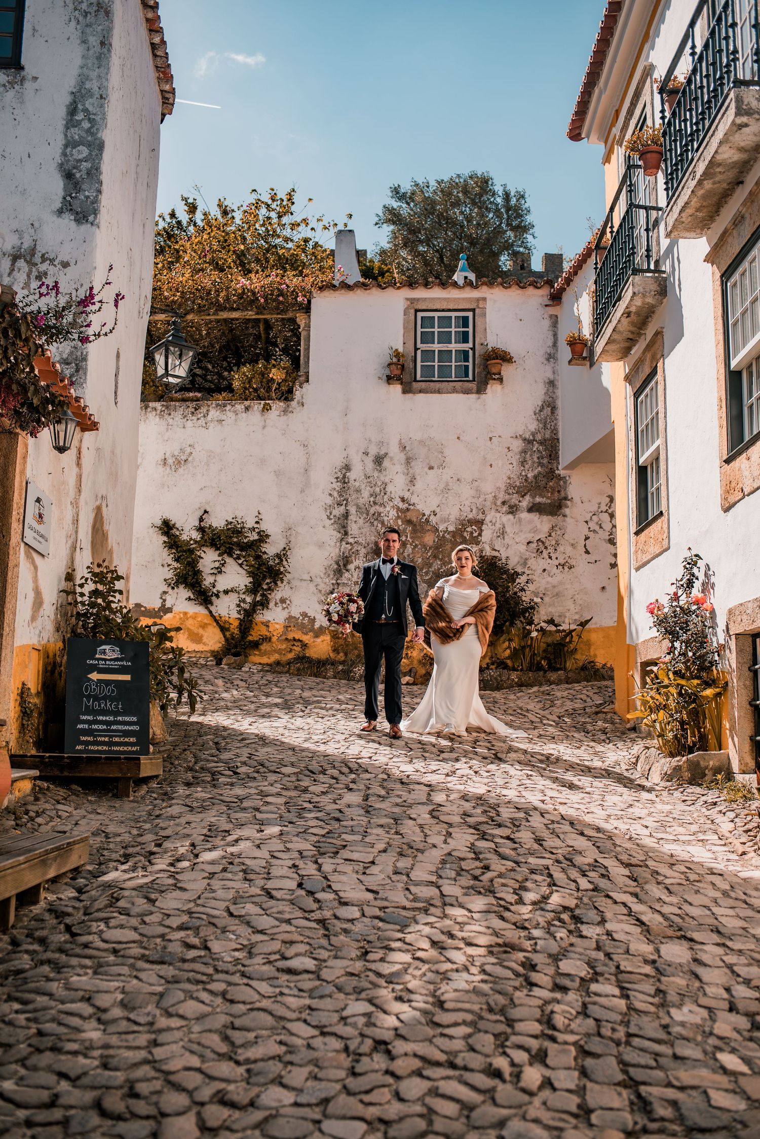 Destination wedding couple sharing a quiet moment in Óbidos, Portugal.