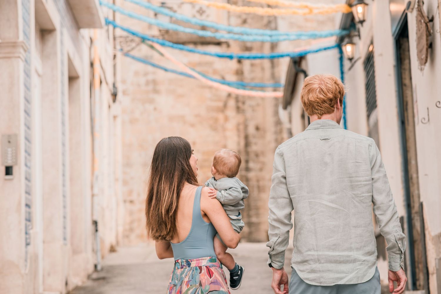 Parents and children sharing a joyful moment during a family session in Lisbon.