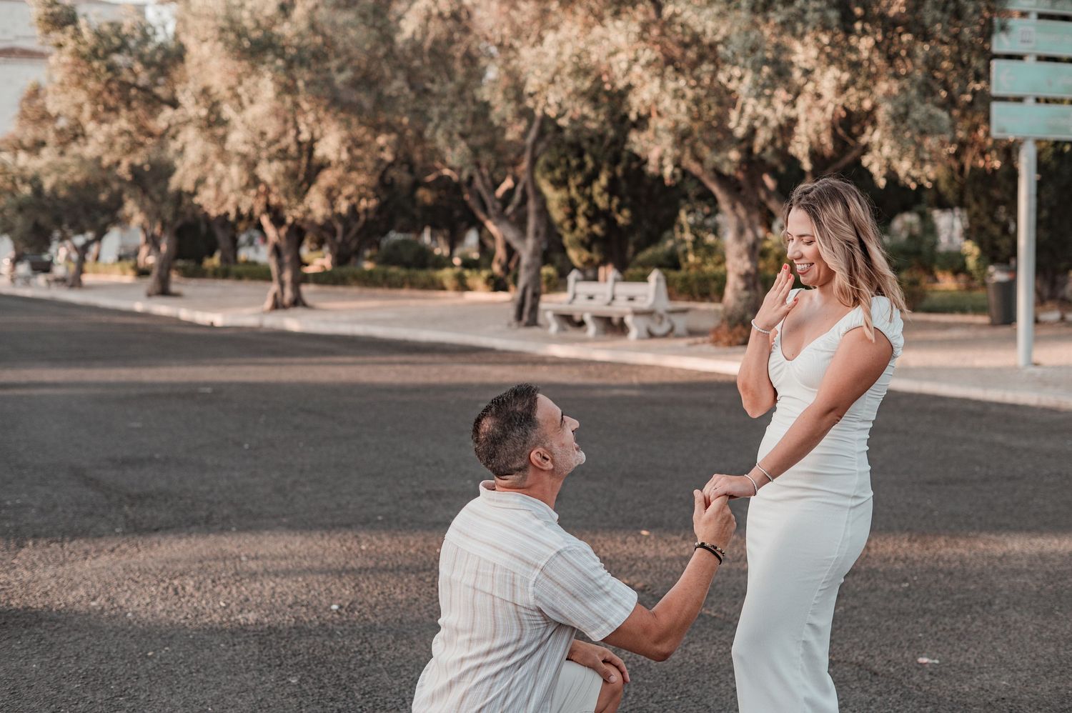Engaged couple sharing an intimate moment in Belém, Lisbon, outdoor photography.