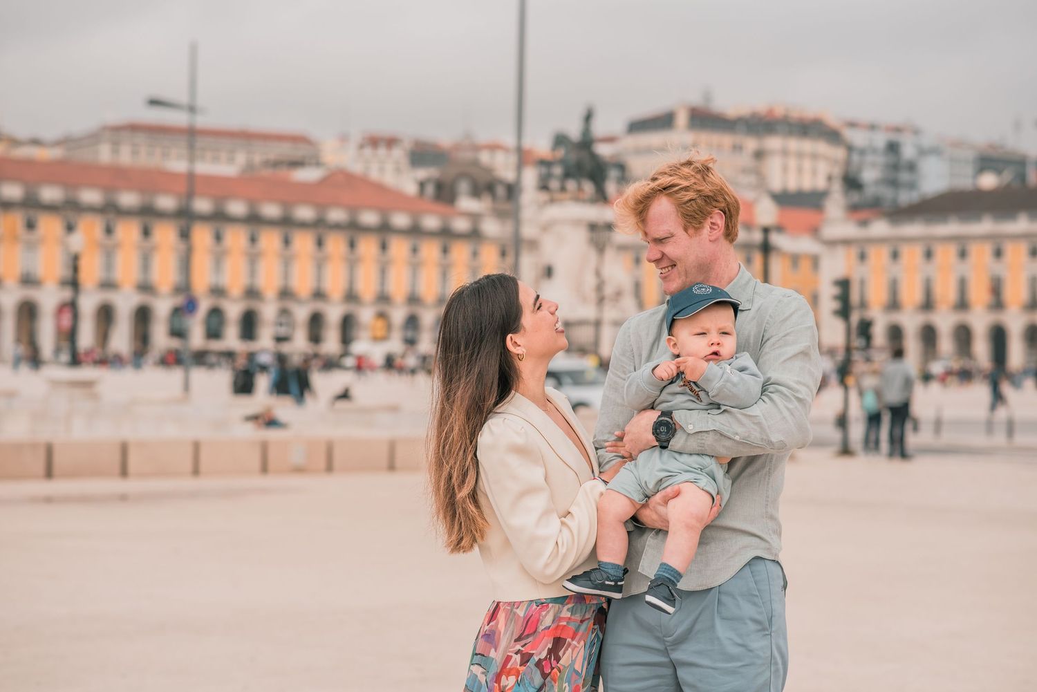 Parents and children sharing a joyful moment during a family session in Lisbon.