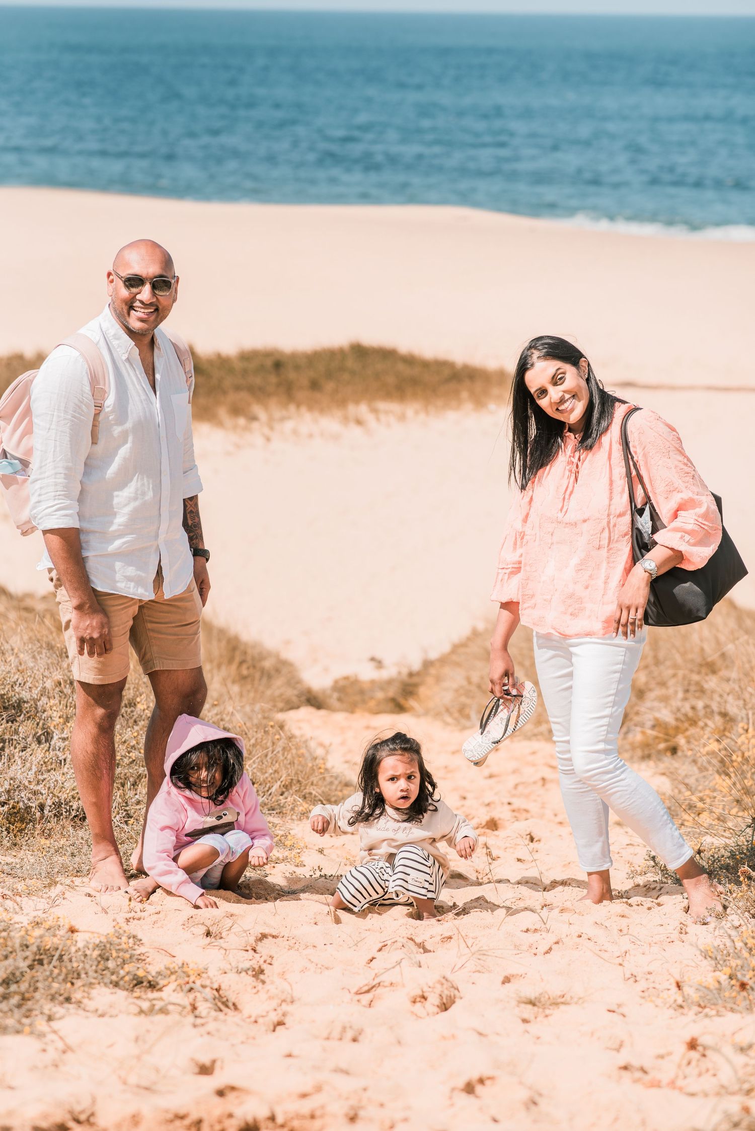 Natural and joyful family moments captured on a Portuguese beach.