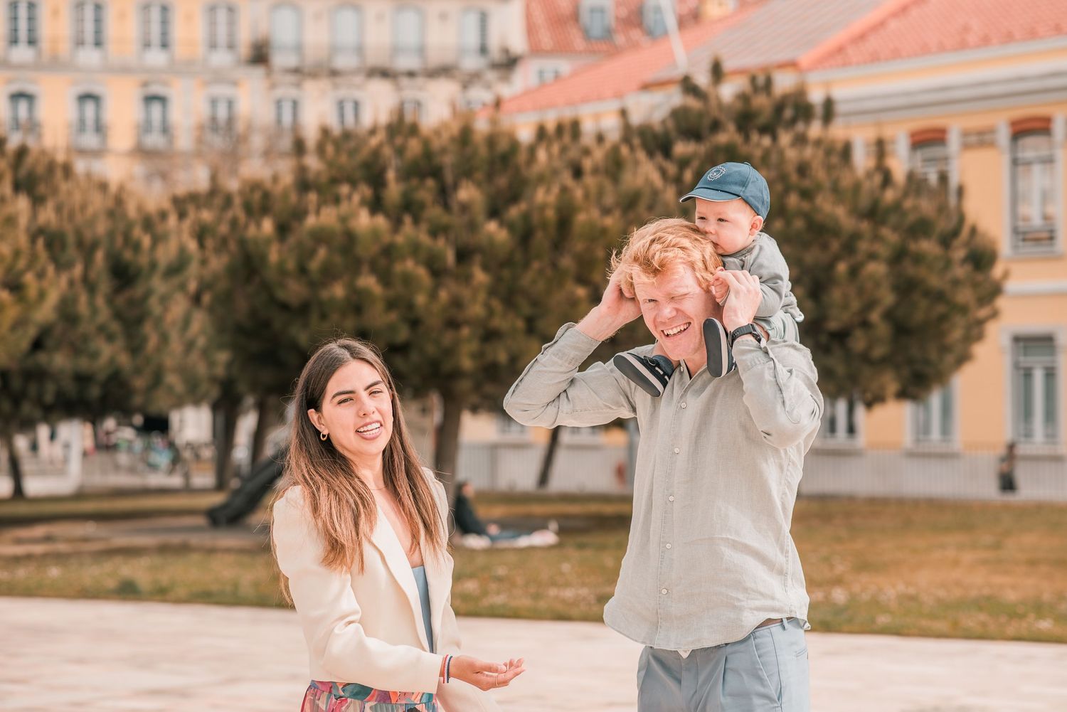 Parents and children sharing a joyful moment during a family session in Lisbon.