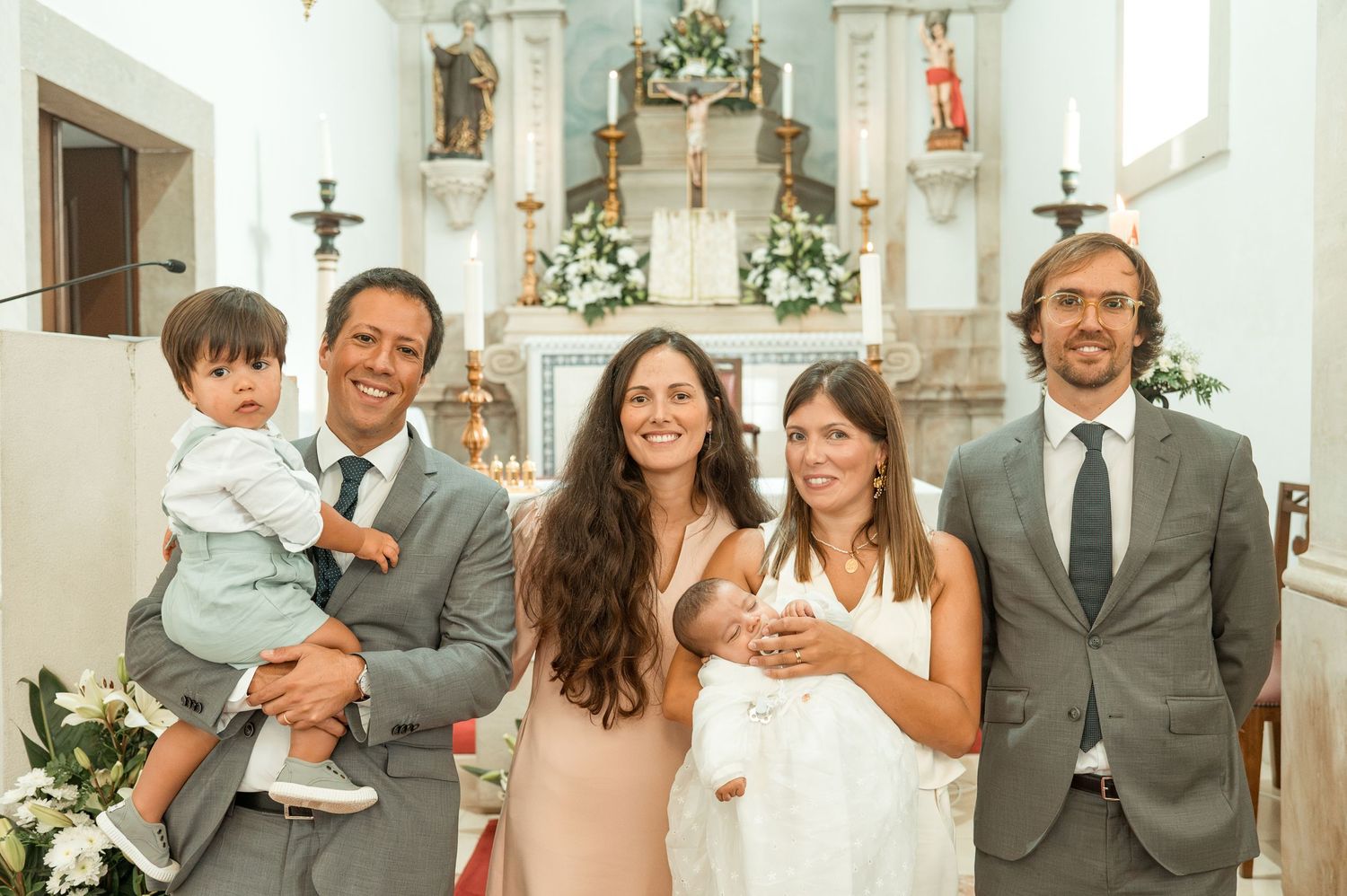 Emotional baptism celebration with family and close friends in Portugal.