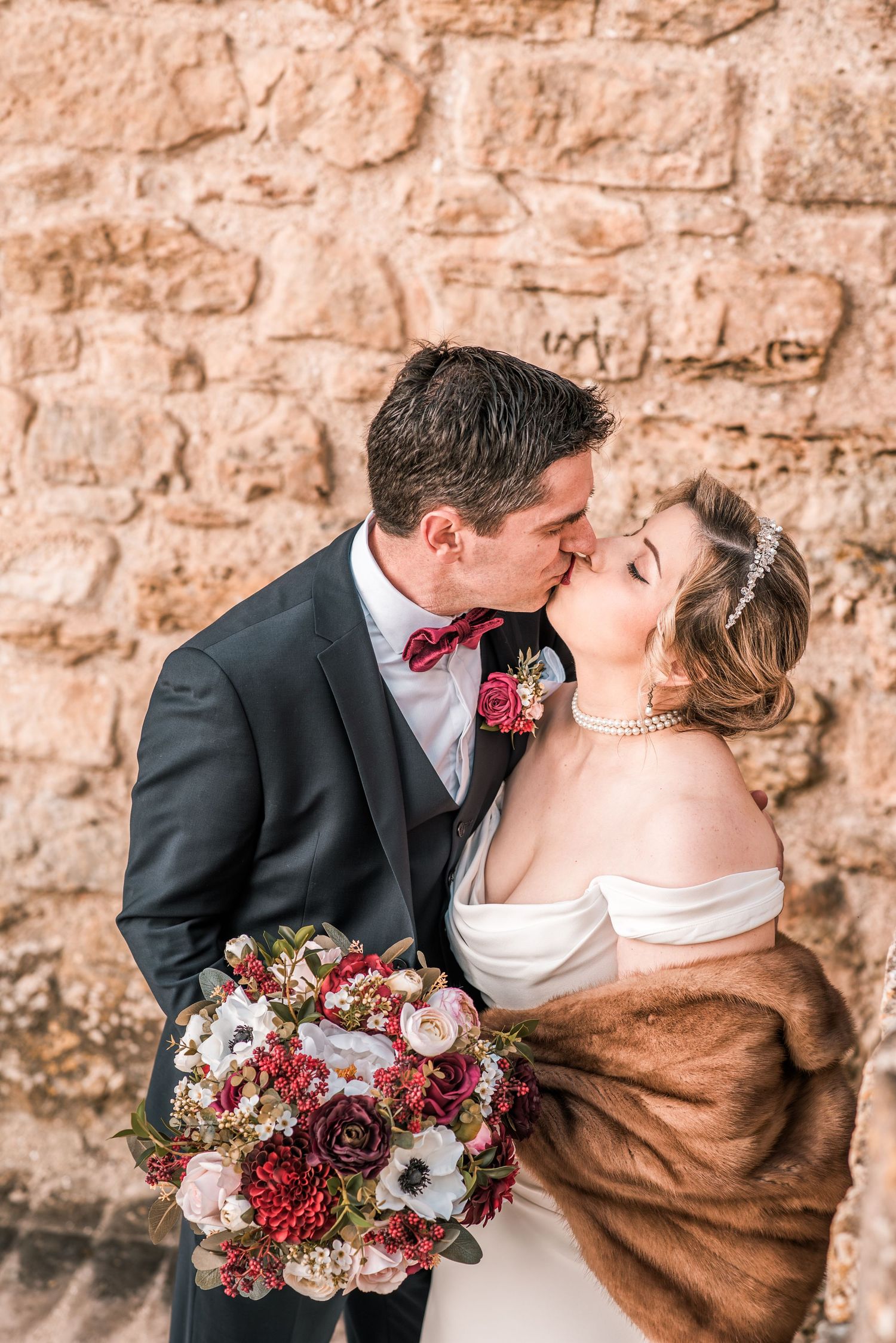 Intimate destination wedding in Óbidos, Portugal, with bride and groom walking through the medieval streets at sunset.