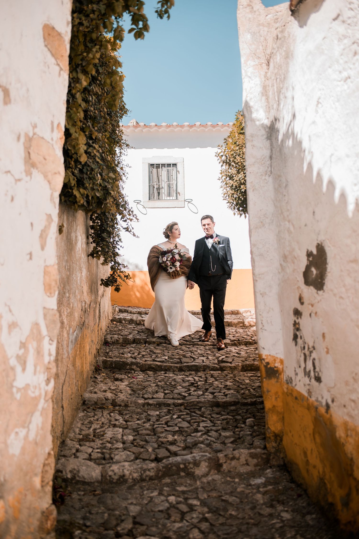 Romantic wedding portraits inside the medieval walls of Óbidos, Portugal.