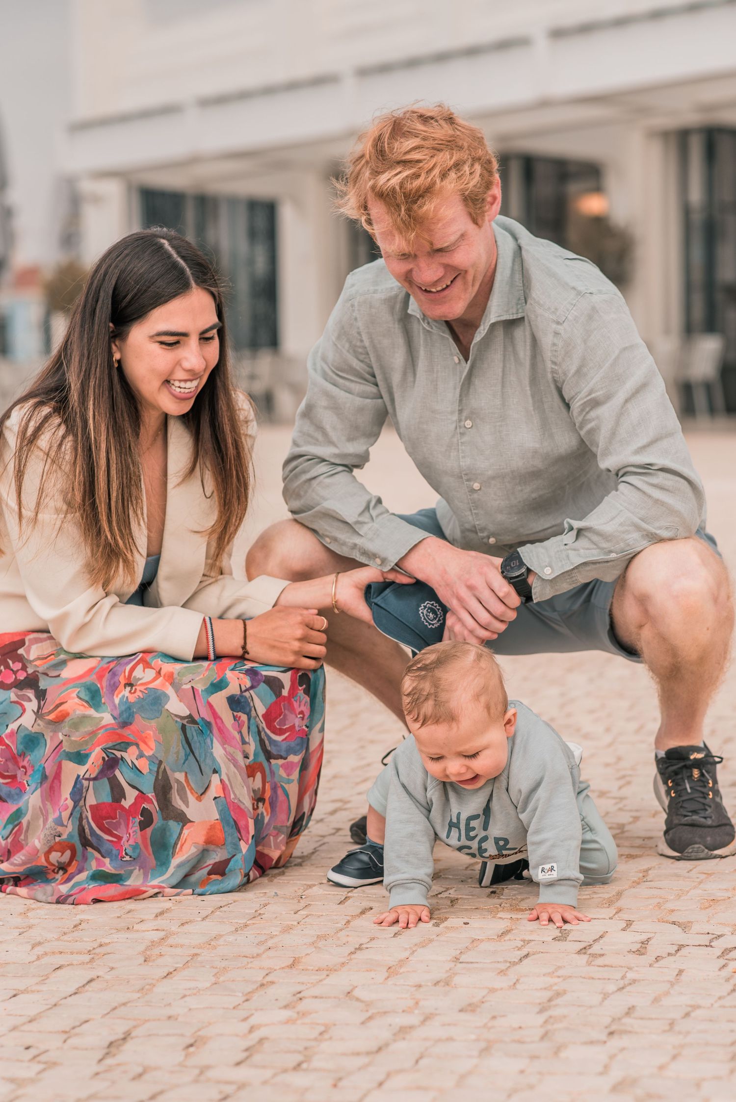 Parents and children sharing a joyful moment during a family session in Lisbon.