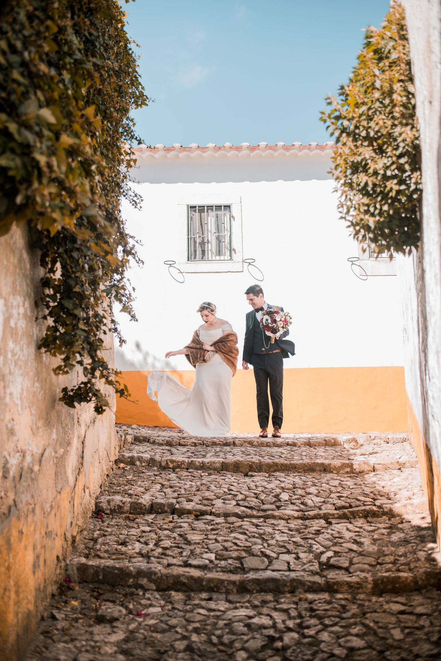Romantic wedding portraits inside the medieval walls of Óbidos, Portugal.