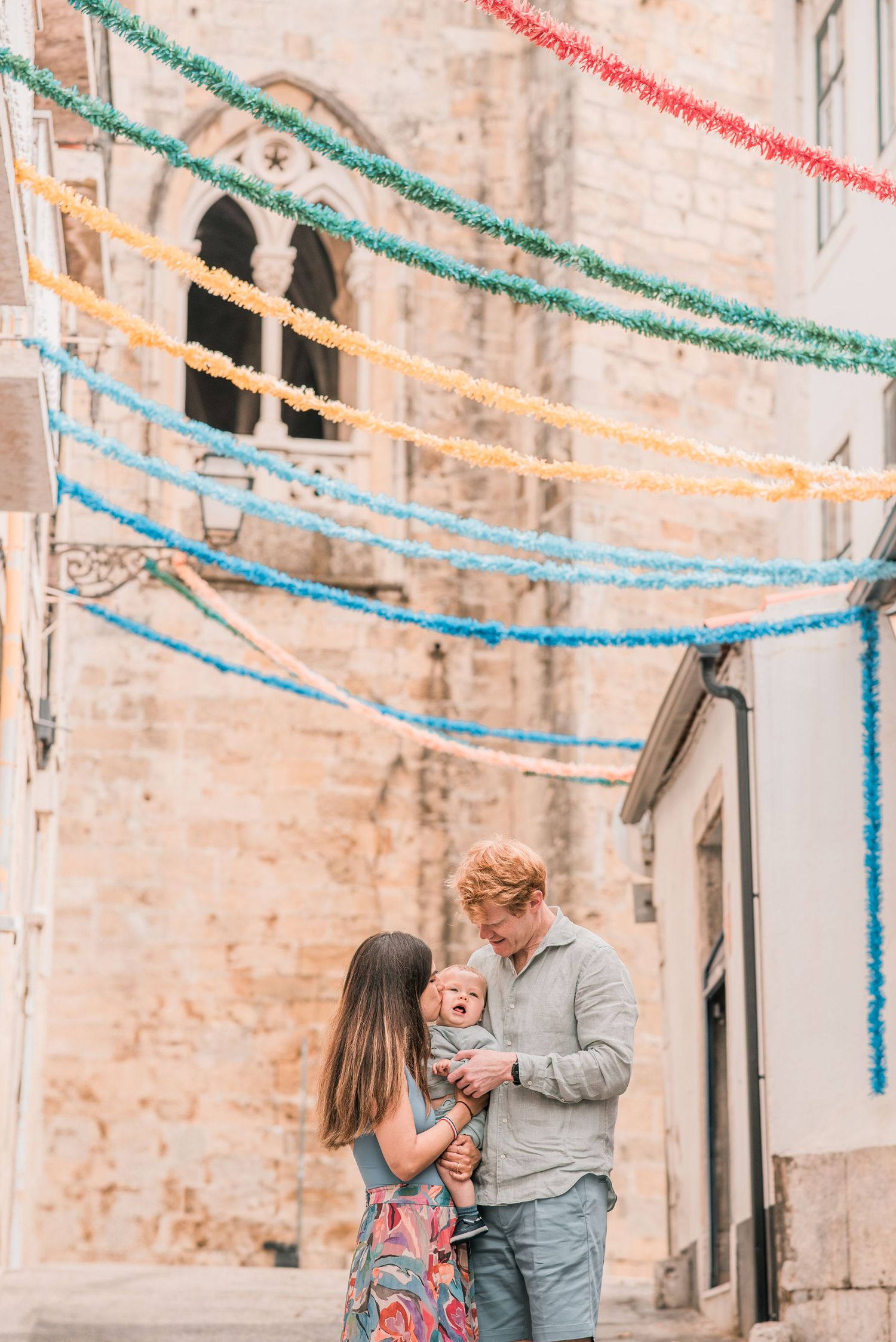 Parents and children sharing a joyful moment during a family session in Lisbon.