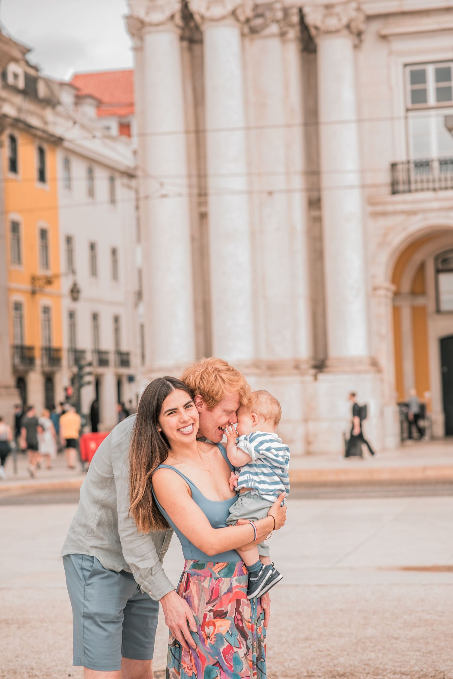 Parents and children sharing a joyful moment during a family session in Lisbon.