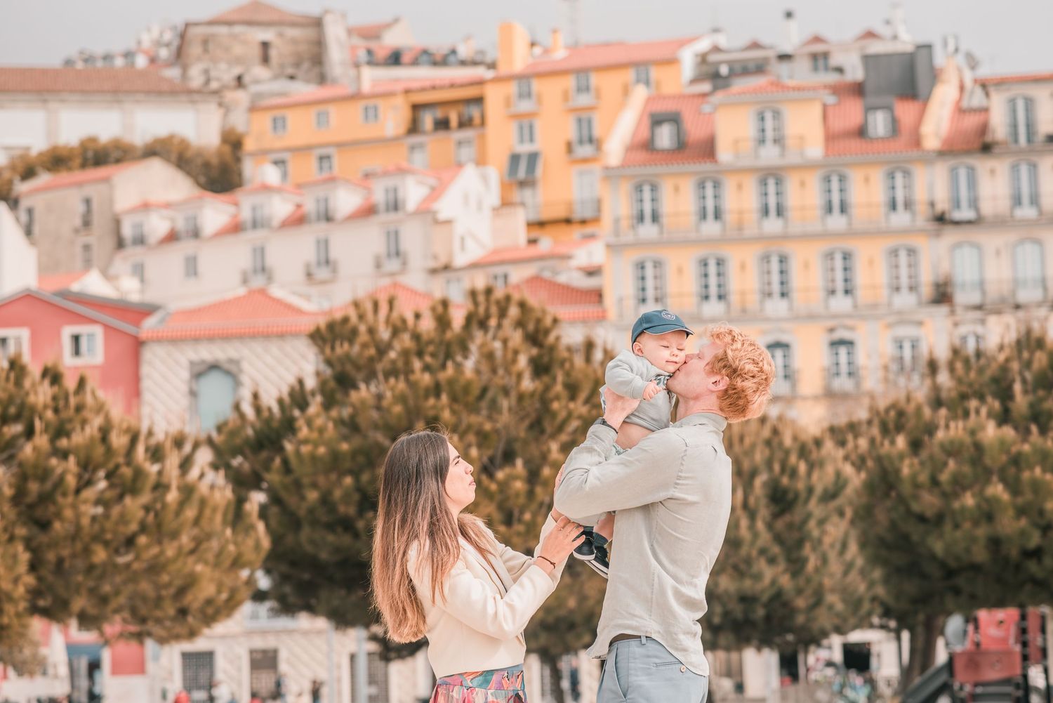Parents and children sharing a joyful moment during a family session in Lisbon.