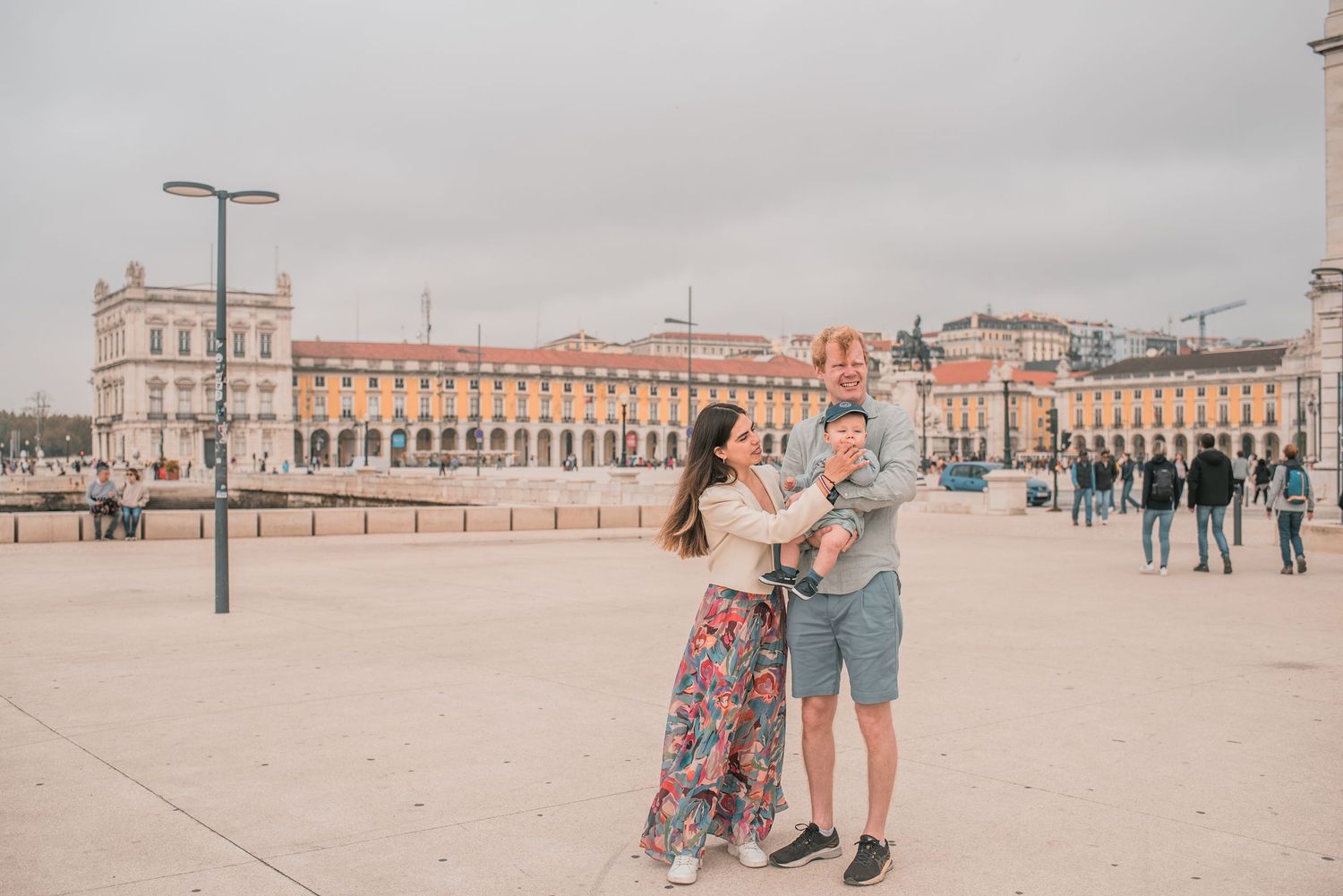 Parents and children sharing a joyful moment during a family session in Lisbon.