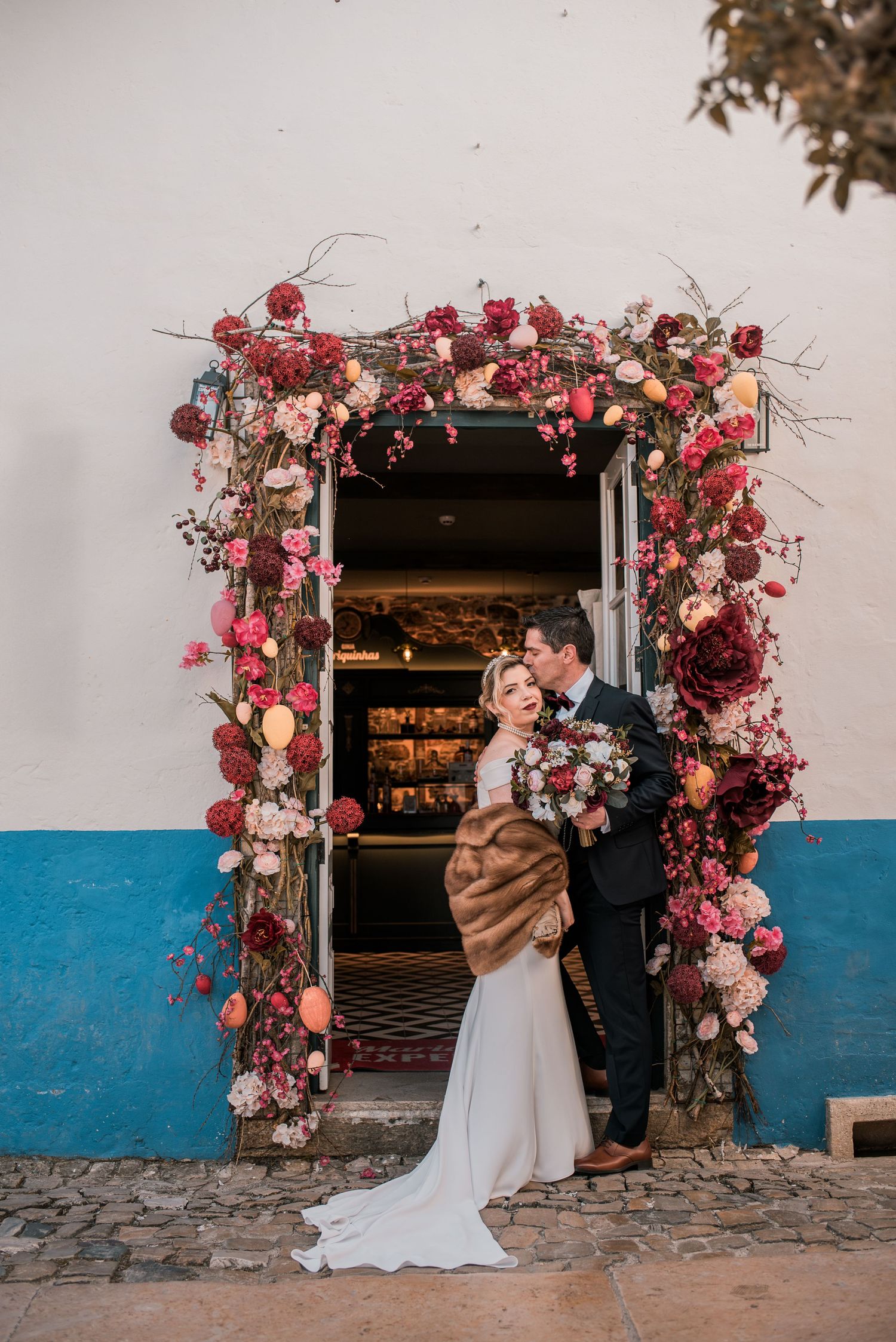 Destination wedding couple sharing a quiet moment in Óbidos, Portugal.