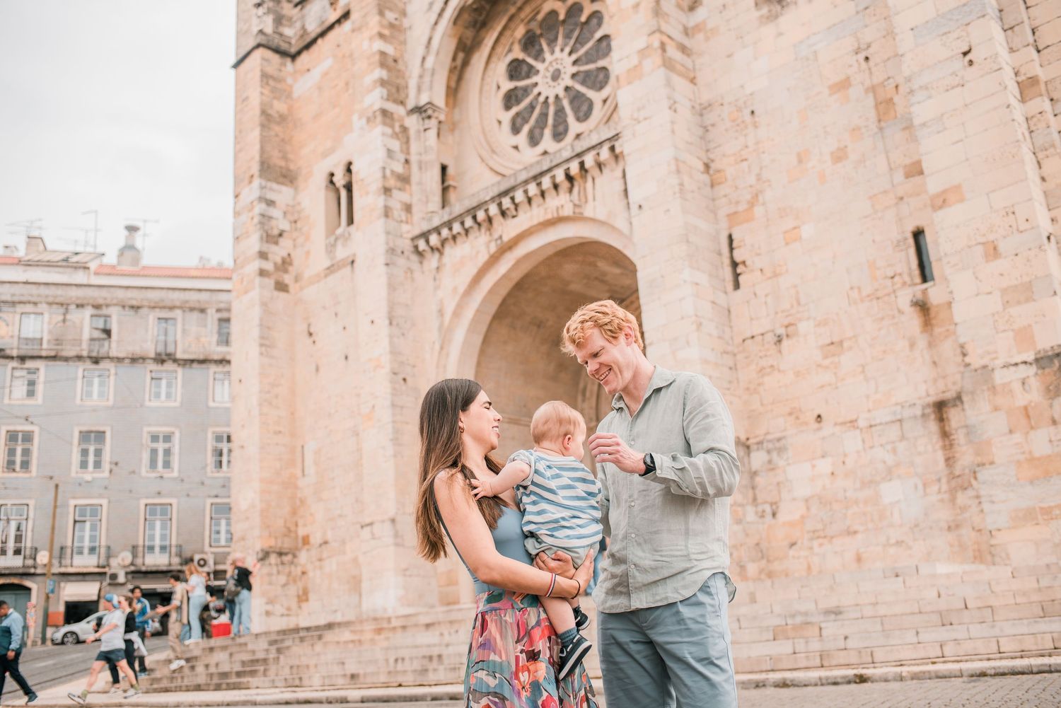 Parents and children sharing a joyful moment during a family session in Lisbon.