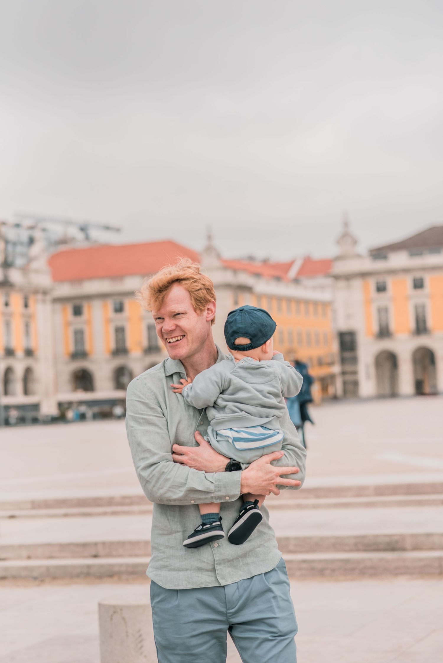 Parents and children sharing a joyful moment during a family session in Lisbon.