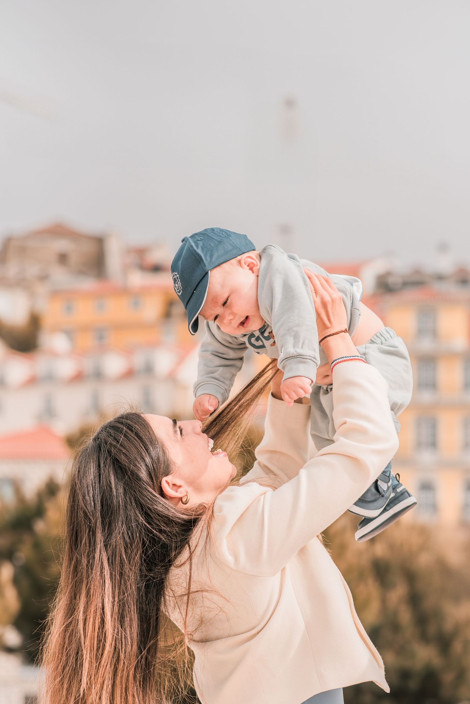 Parents and children sharing a joyful moment during a family session in Lisbon.