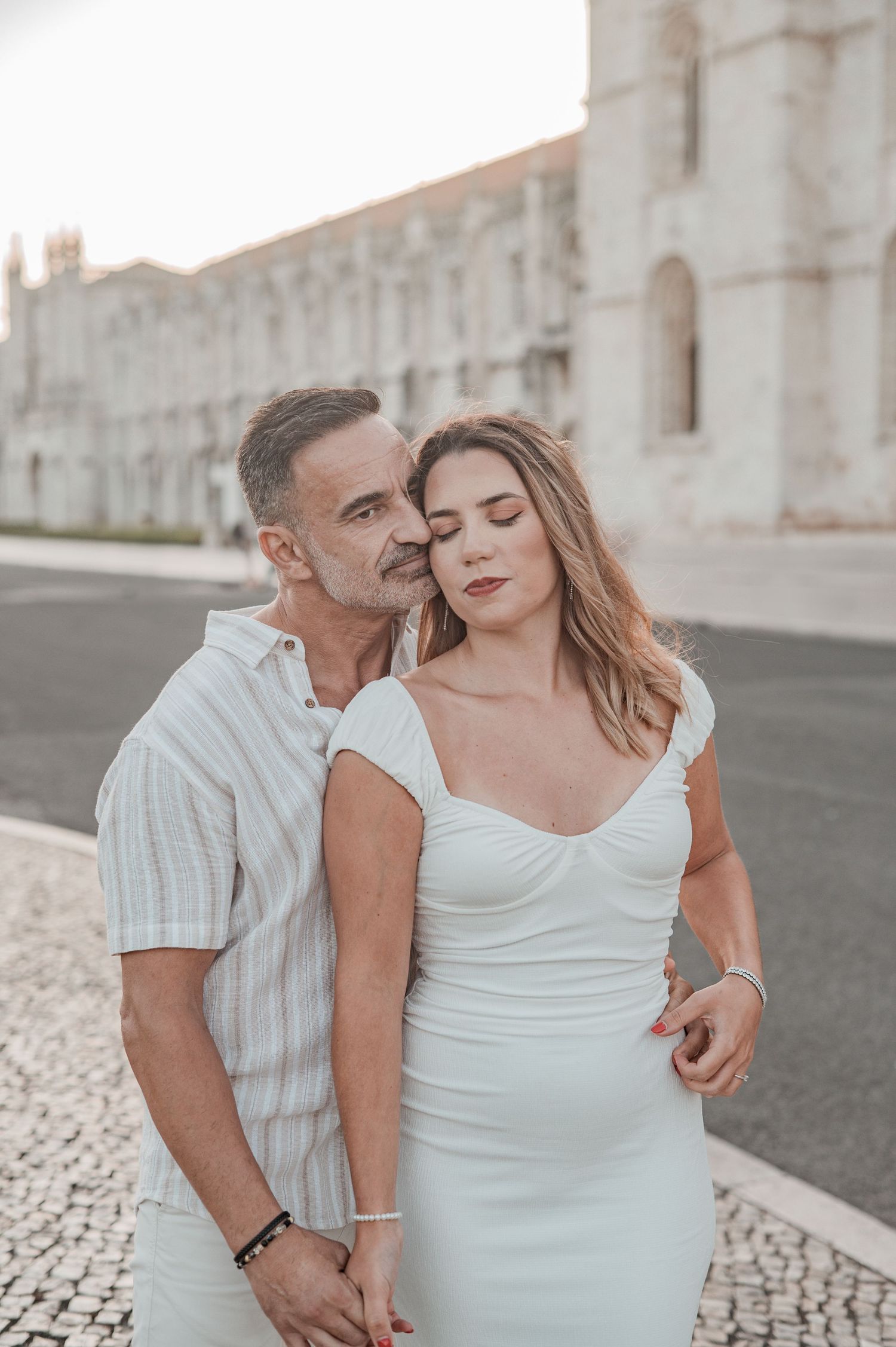 Engagement photography in Belém, Lisbon, capturing a couple walking hand in hand.