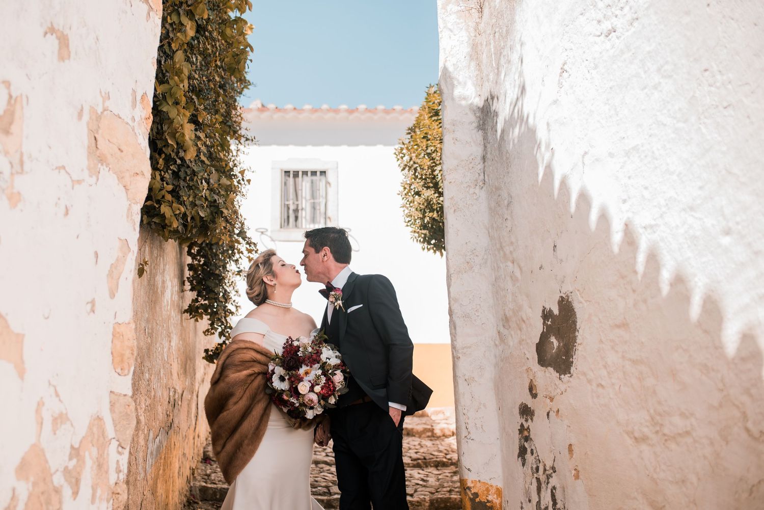 Romantic wedding portraits inside the medieval walls of Óbidos, Portugal.