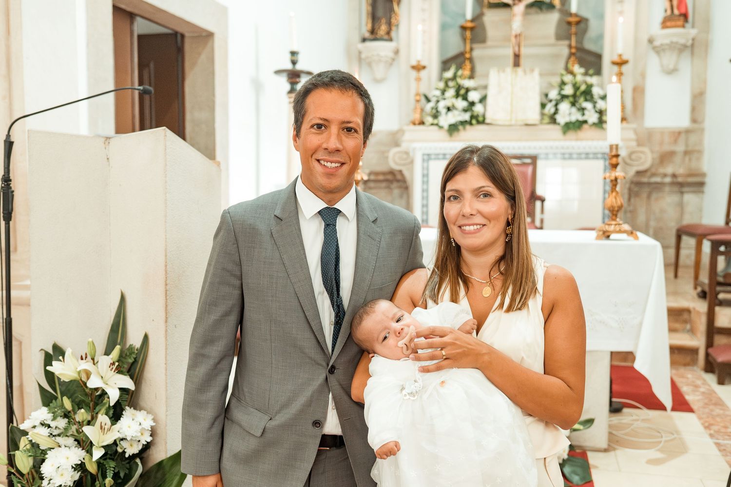Emotional baptism celebration with family and close friends in Portugal.