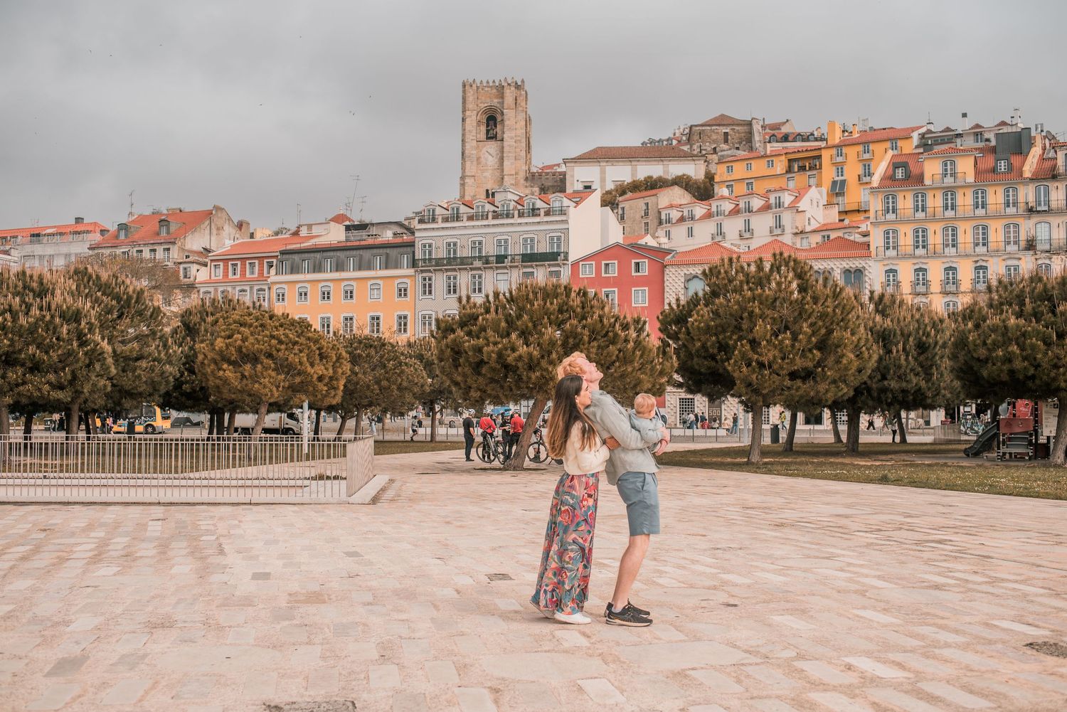 Parents and children sharing a joyful moment during a family session in Lisbon.
