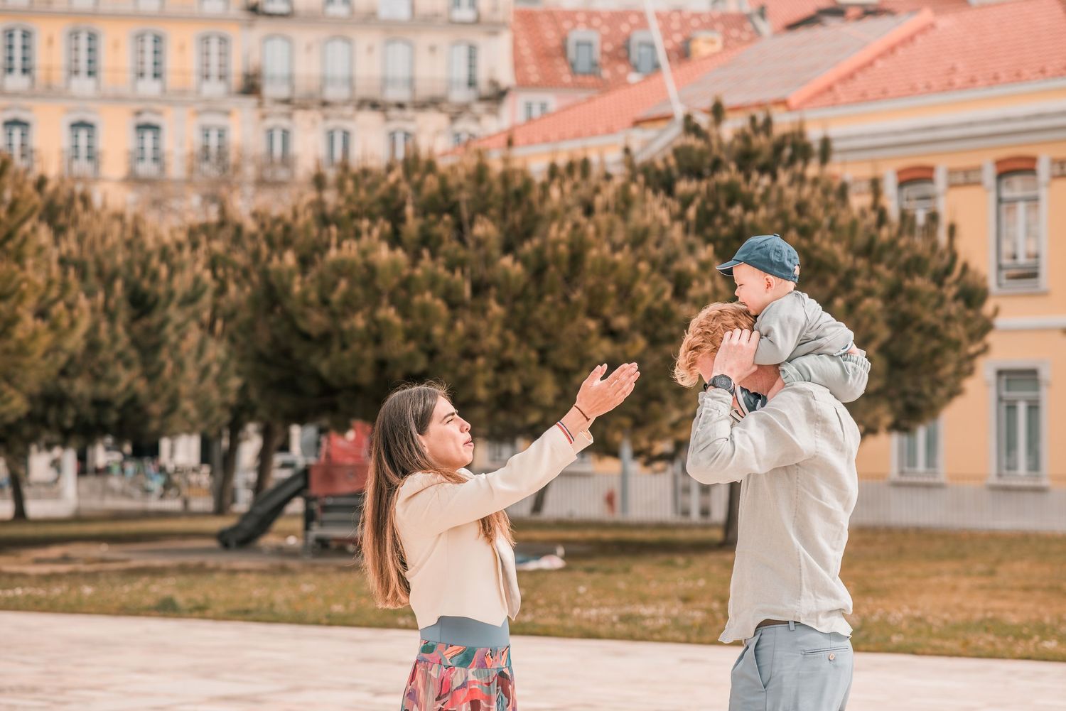 Parents and children sharing a joyful moment during a family session in Lisbon.