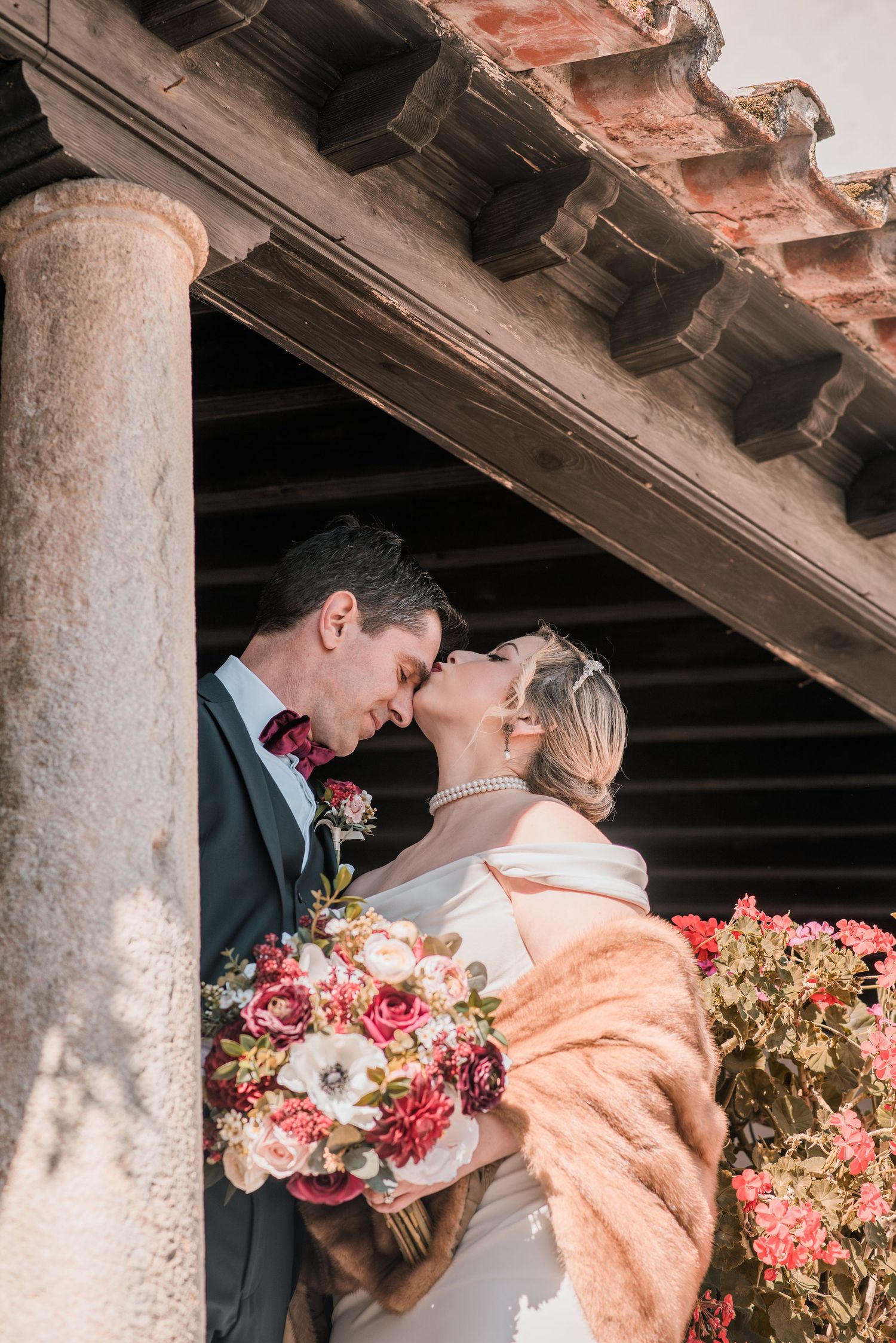 Intimate destination wedding in Óbidos, Portugal, with bride and groom walking through the medieval streets at sunset.