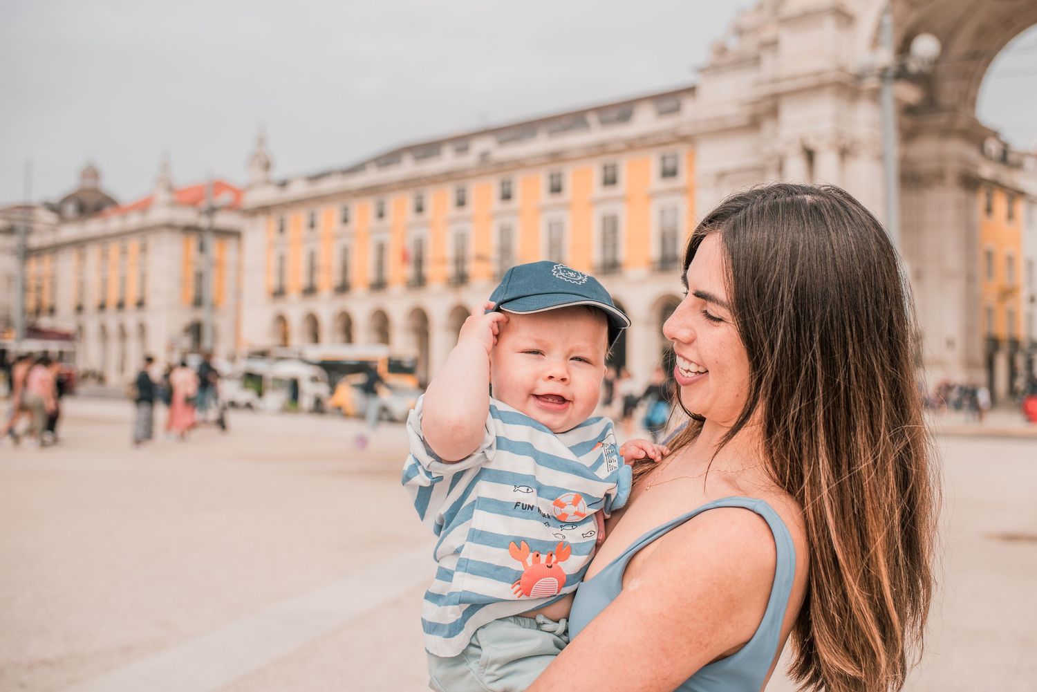 Parents and children sharing a joyful moment during a family session in Lisbon.