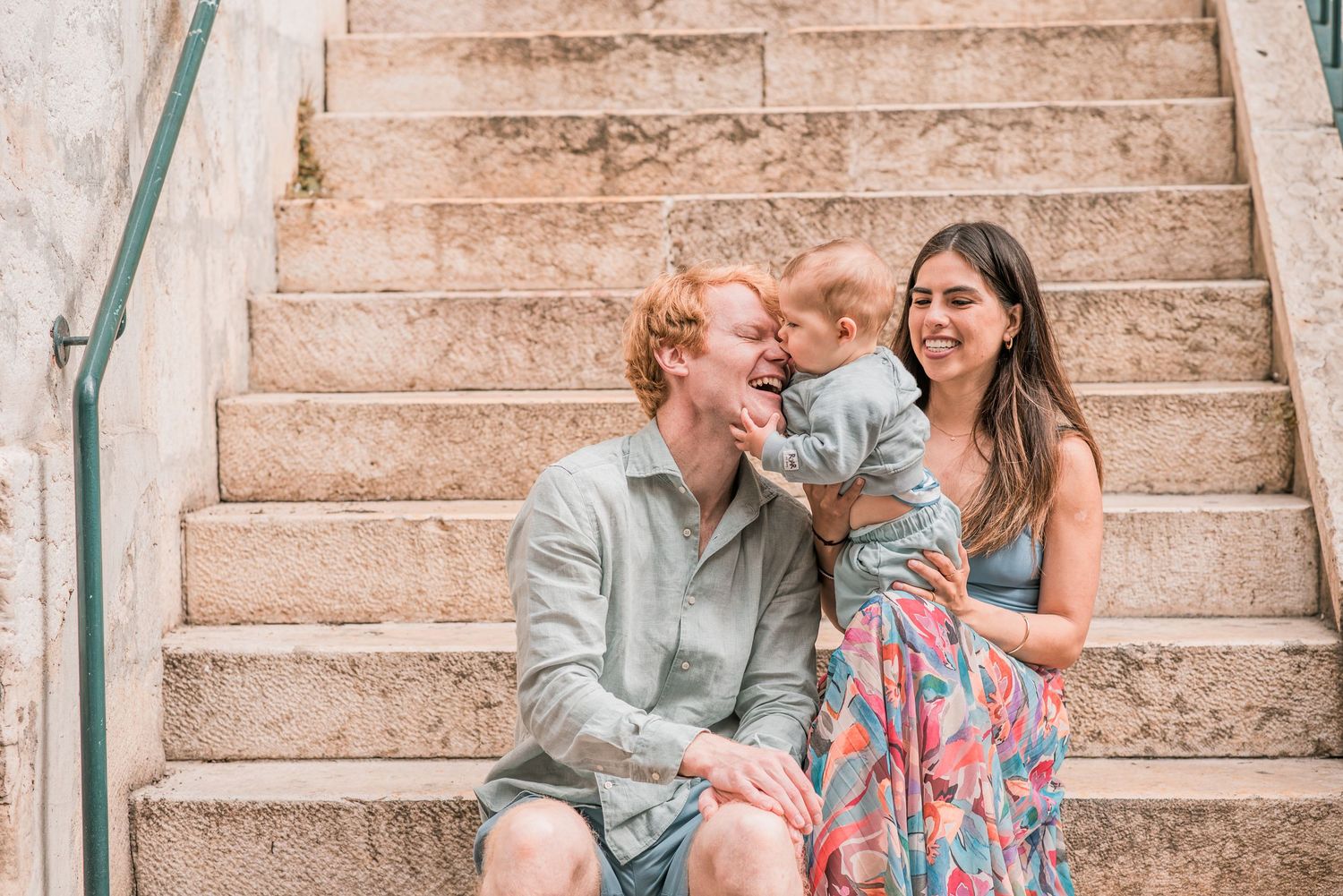 Parents and children sharing a joyful moment during a family session in Lisbon.