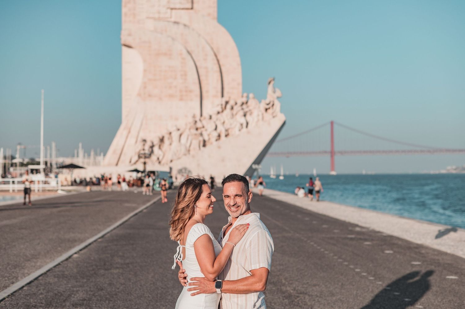 Engaged couple sharing an intimate moment in Belém, Lisbon, outdoor photography.