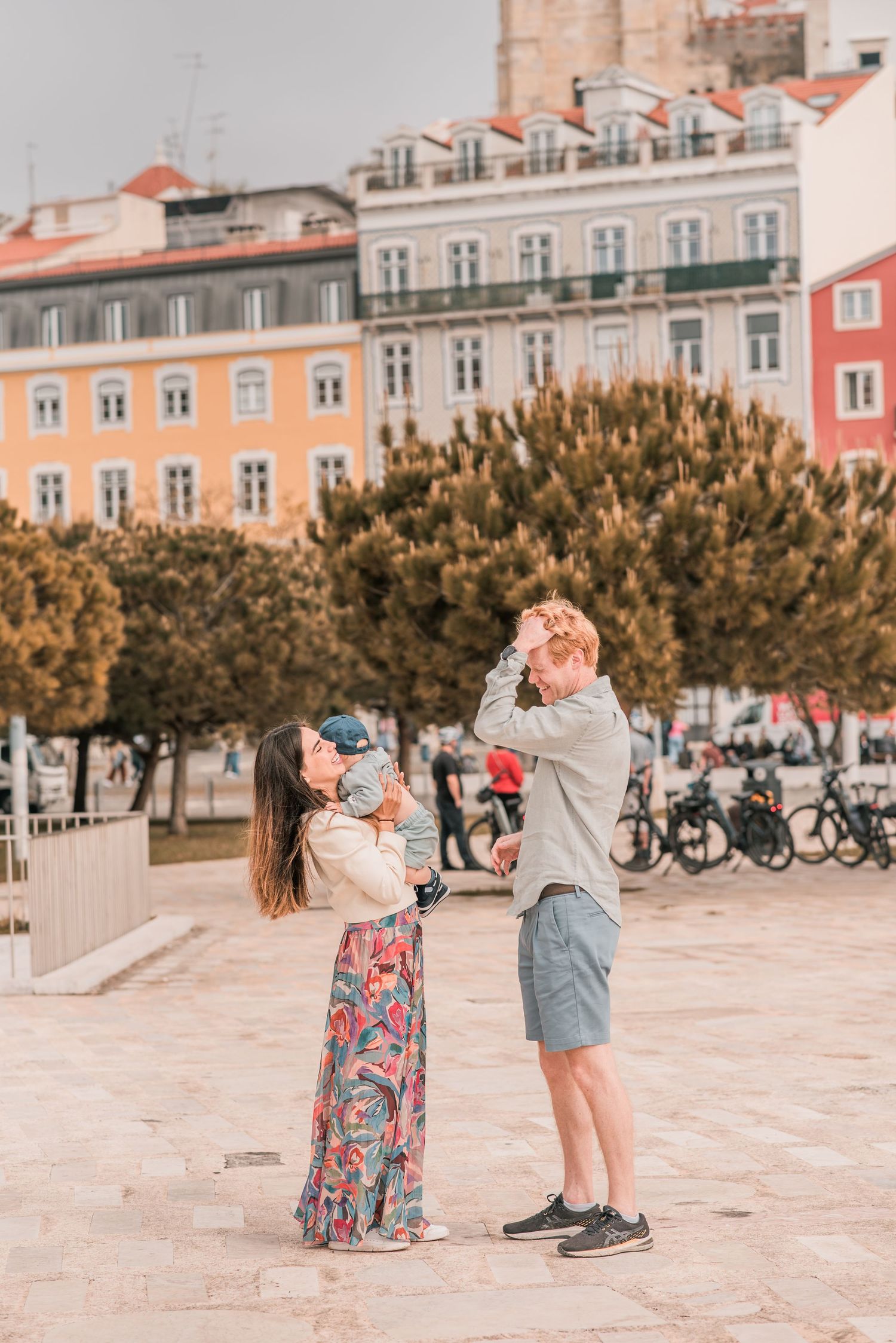 Parents and children sharing a joyful moment during a family session in Lisbon.
