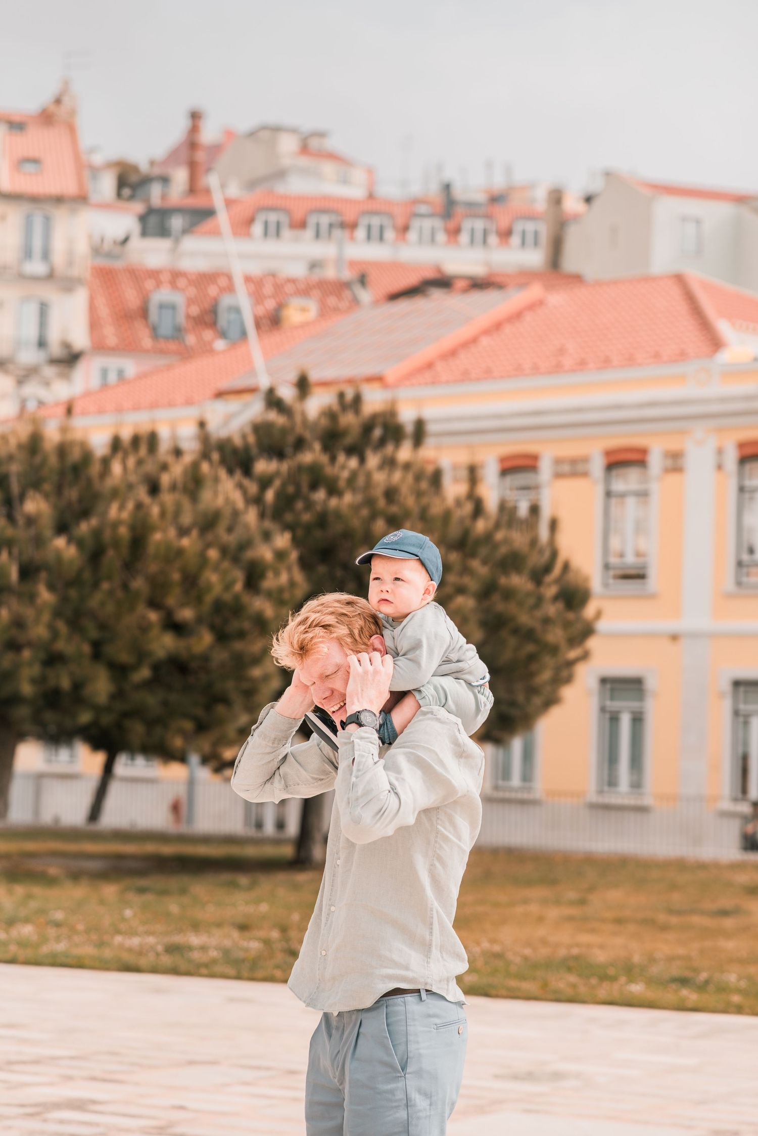 Parents and children sharing a joyful moment during a family session in Lisbon.