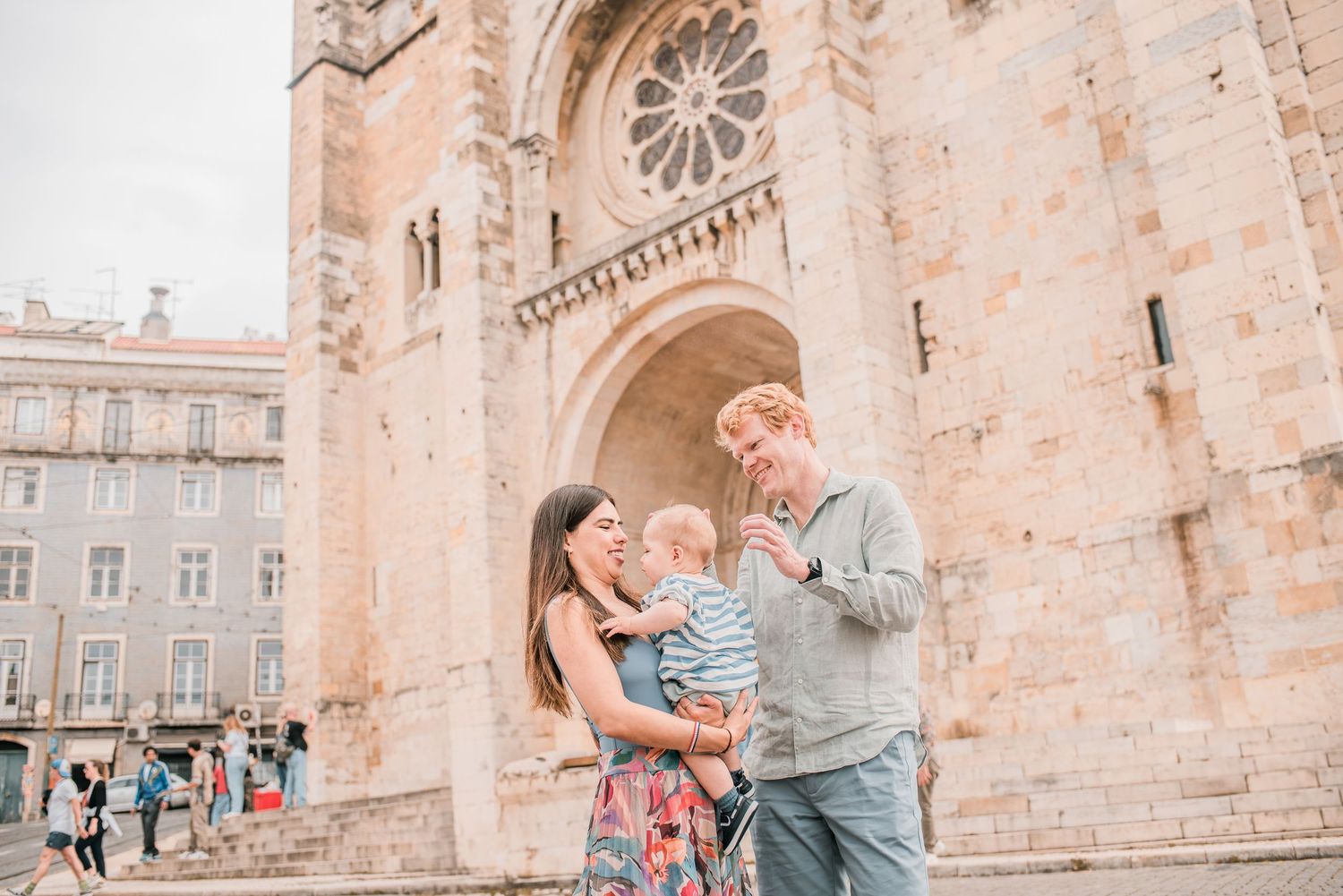 Parents and children sharing a joyful moment during a family session in Lisbon.