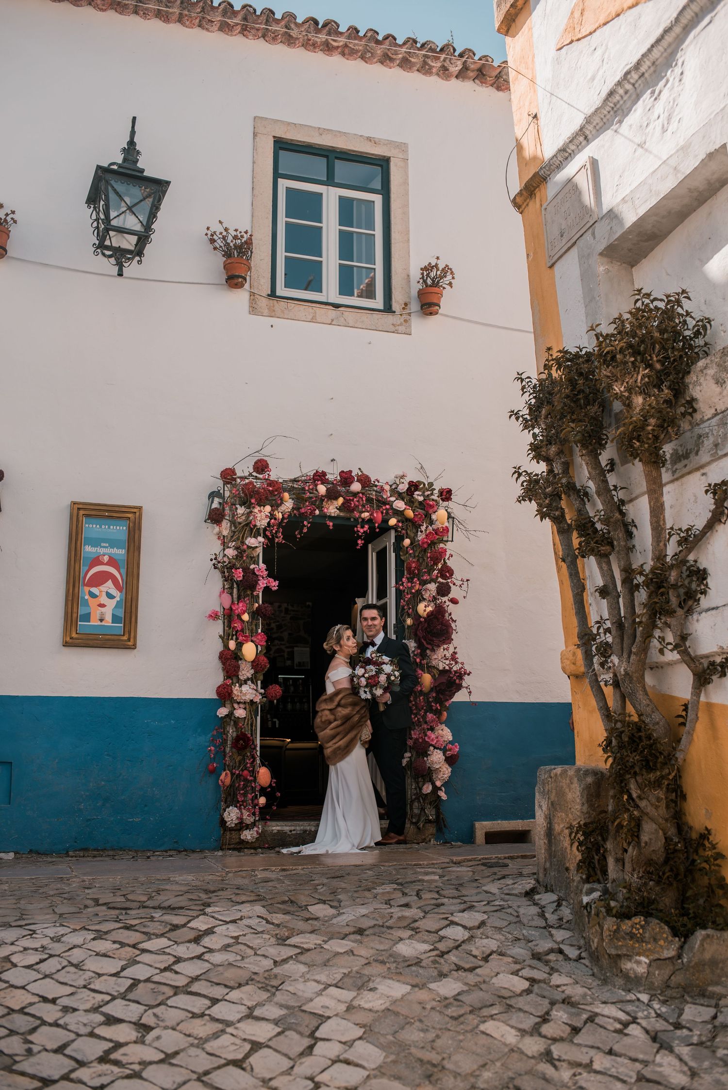 Destination wedding couple sharing a quiet moment in Óbidos, Portugal.