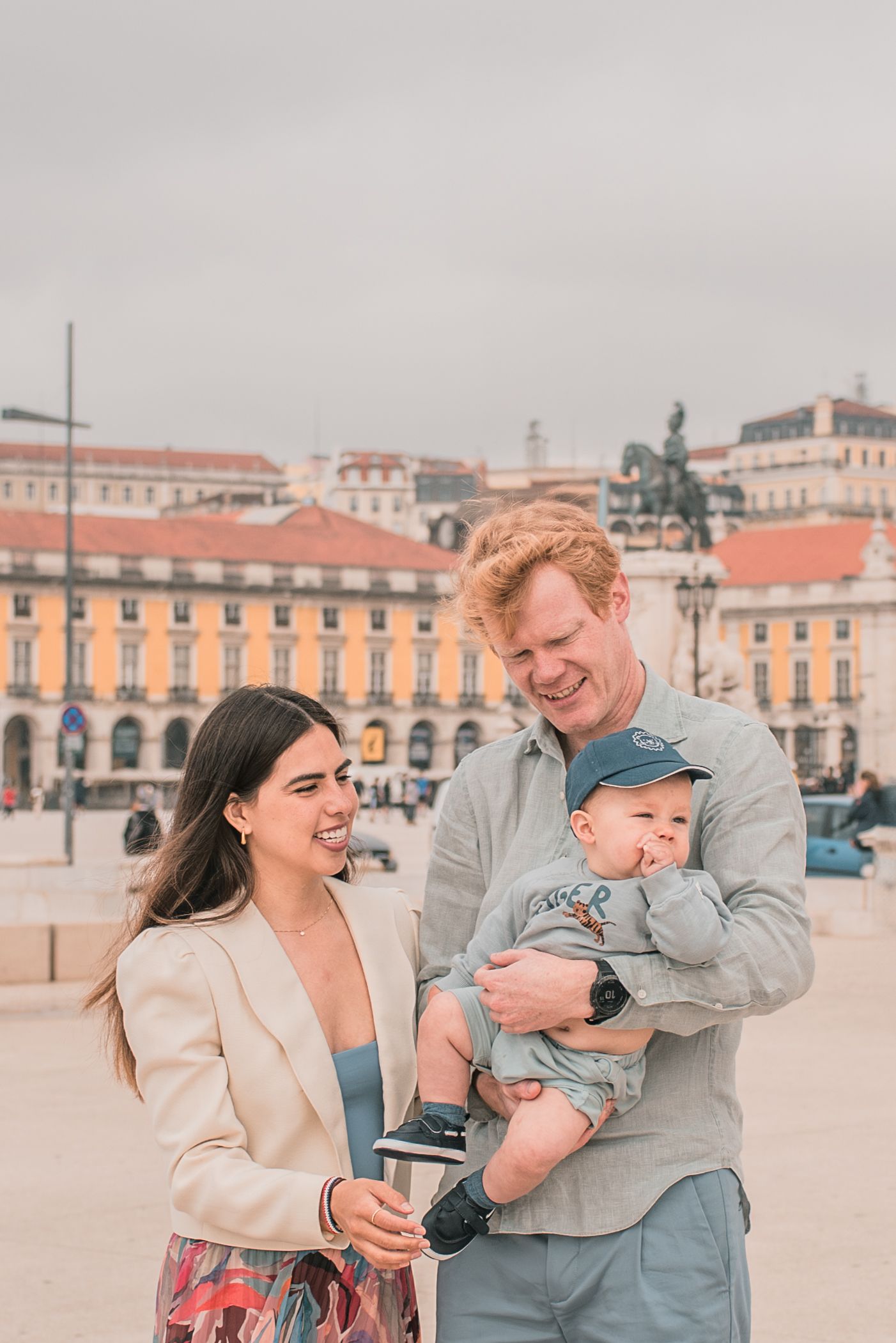 Parents and children sharing a joyful moment during a family session in Lisbon.
