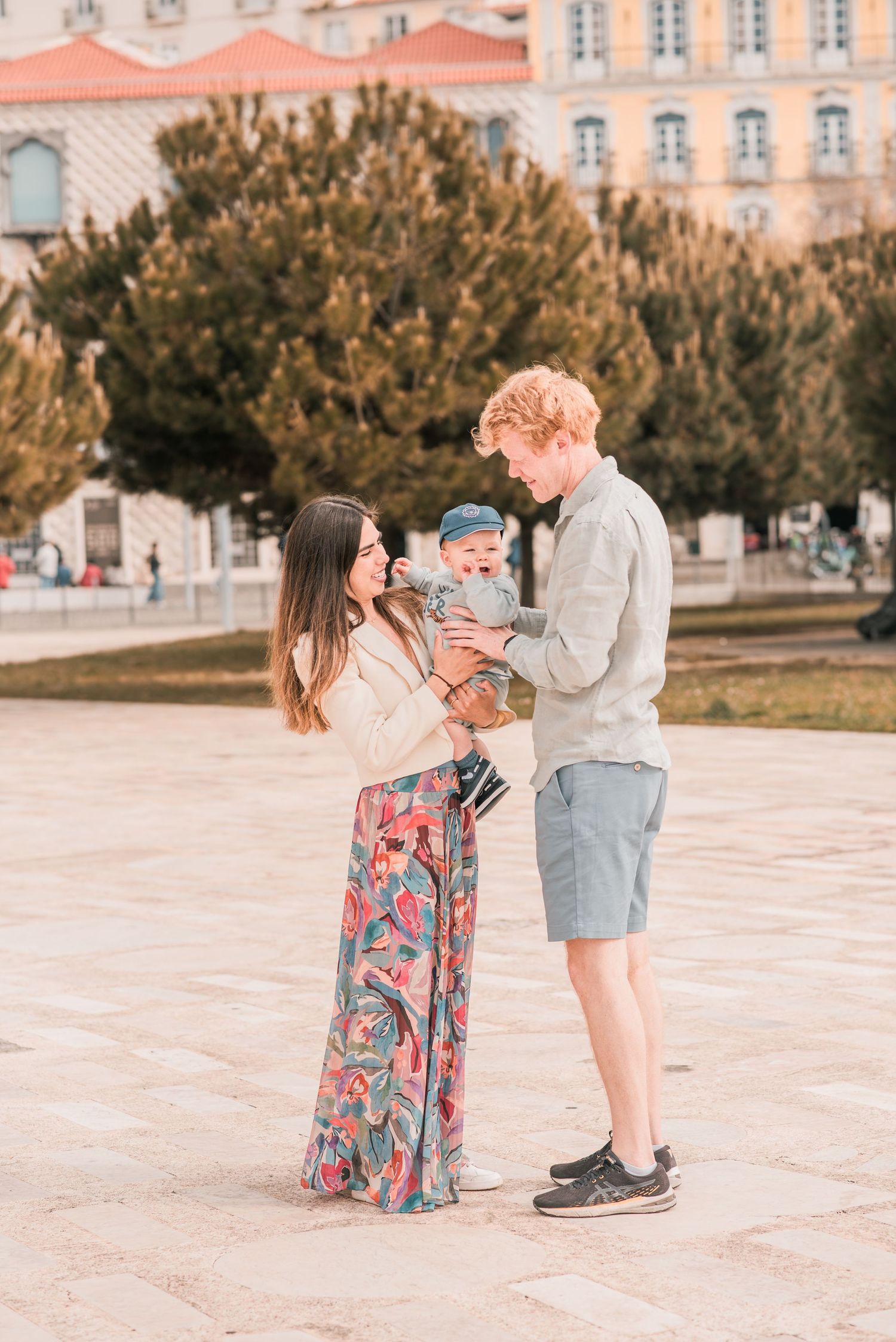 Parents and children sharing a joyful moment during a family session in Lisbon.