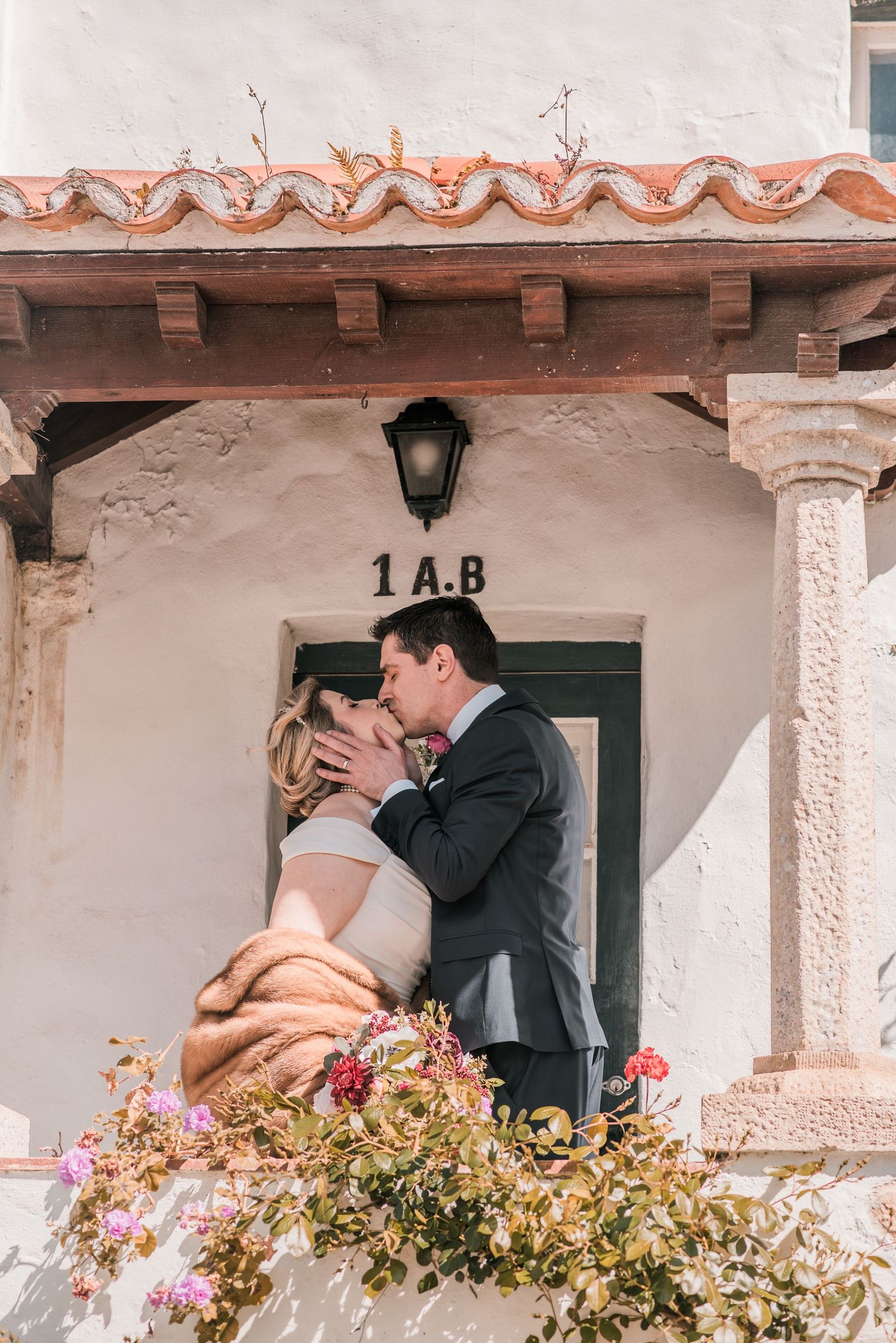 Bride and groom embracing in the historic streets of Óbidos during a destination wedding in Portugal.