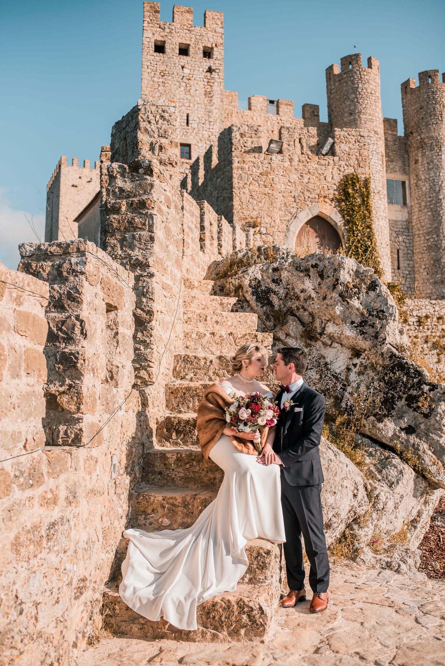 Destination wedding couple sharing a quiet moment in Óbidos, Portugal.