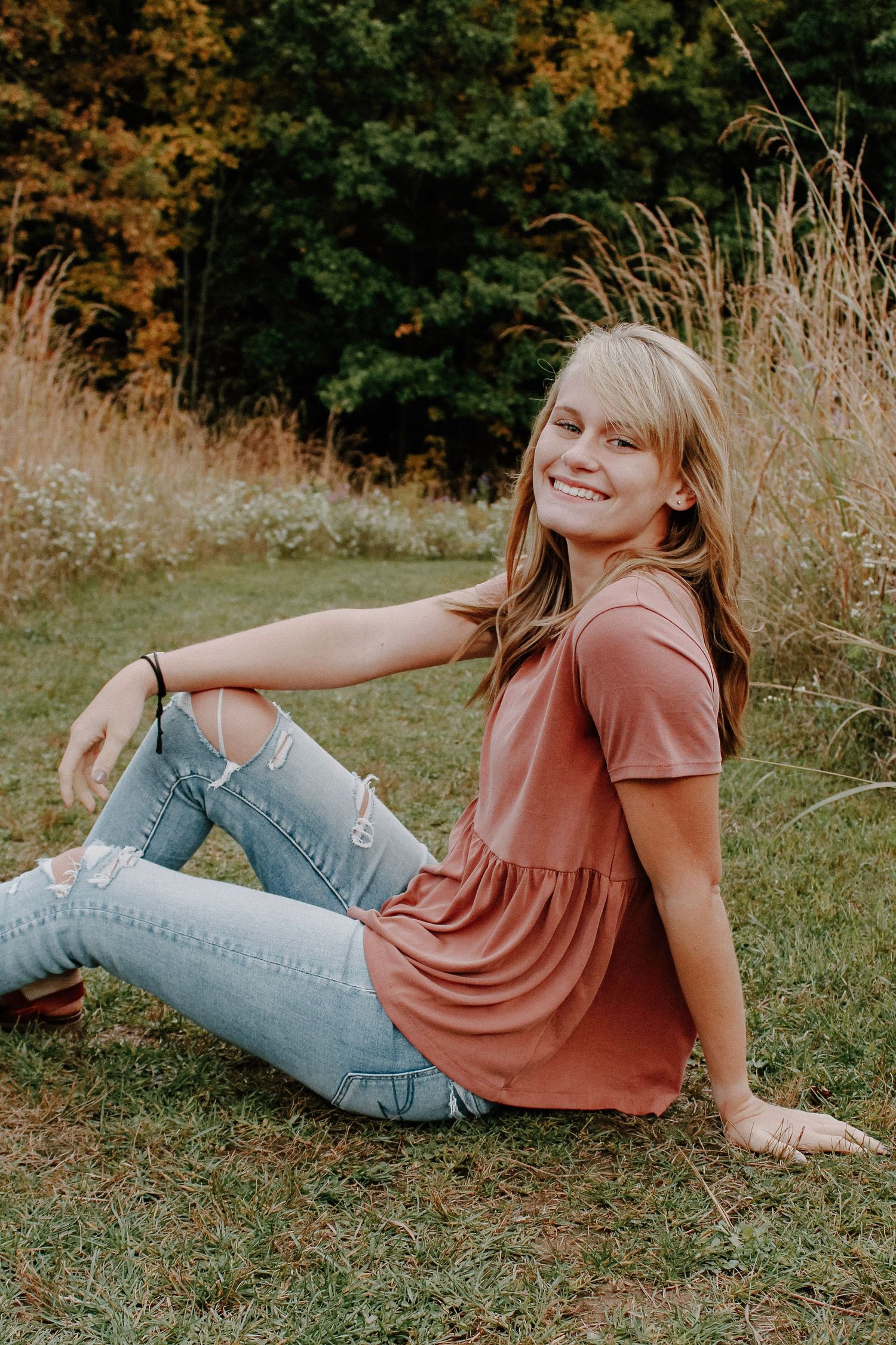 Senior girl in a field during golden hour at Grand Ravines Park.