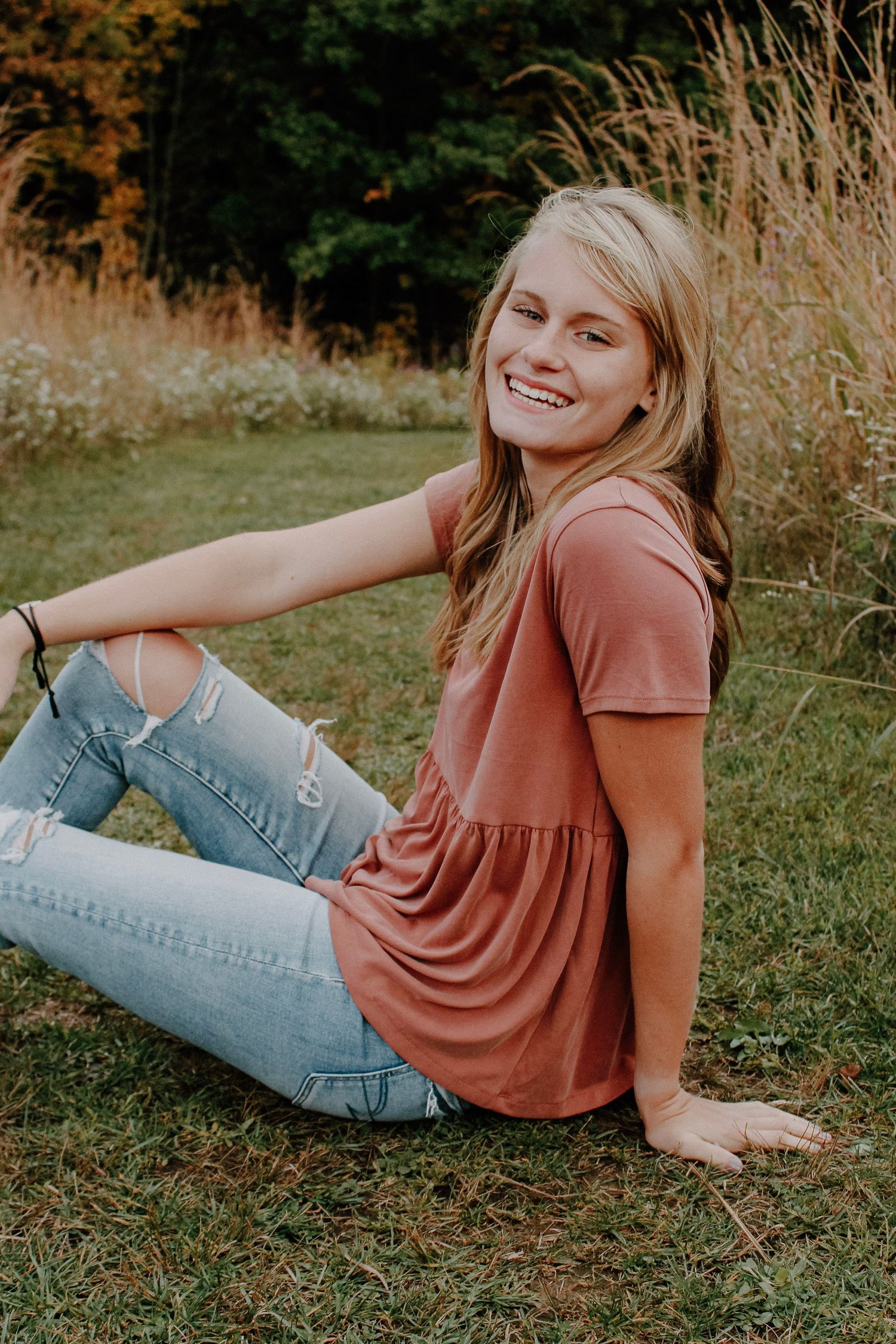 Senior girl in a field during golden hour.