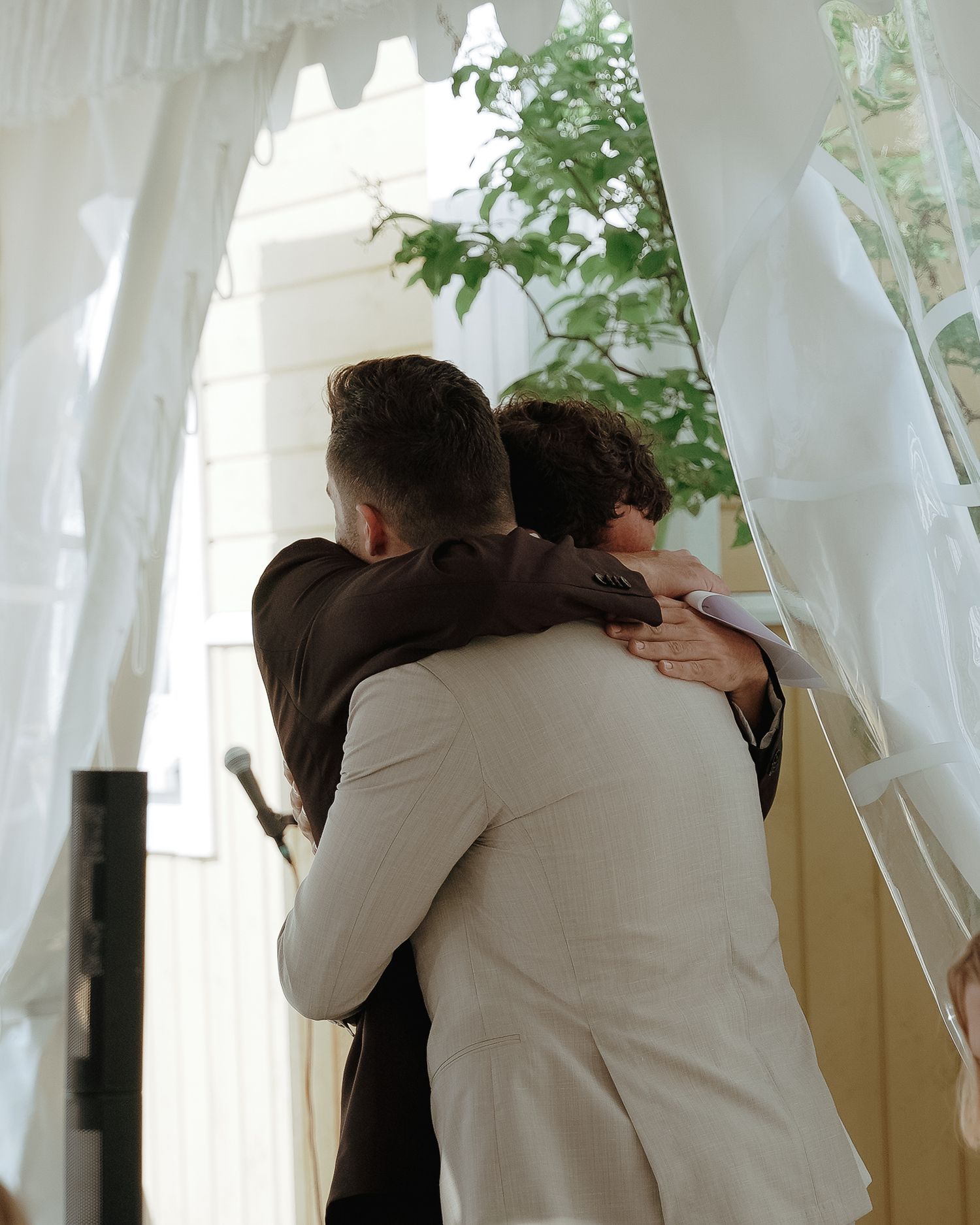 Image shows a series of photos depicting an intimate embrace between two figures wearing white and brown clothing.