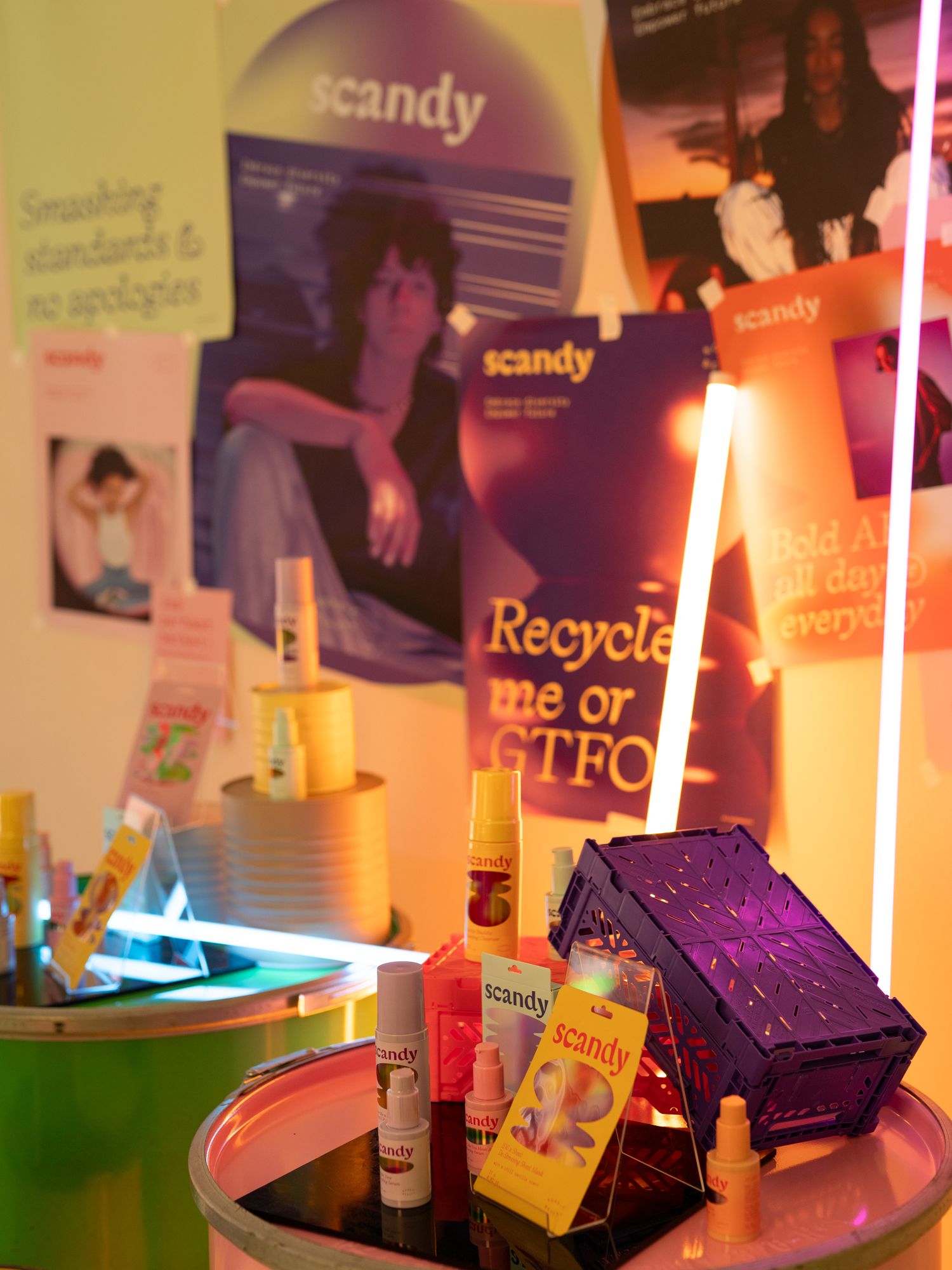 Icandy brand marketing materials and products displayed with colorful lighting and posters on a wall.