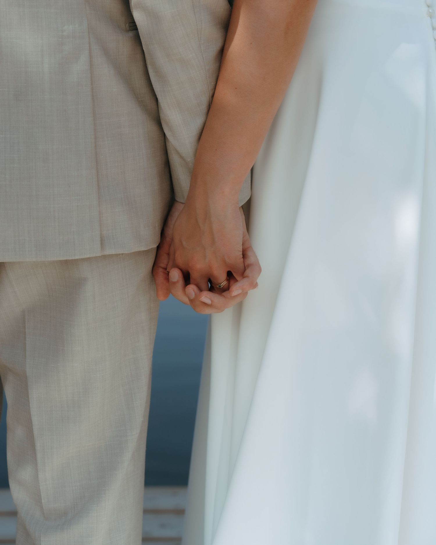 Close up details of hands against white linen clothing showing various natural poses and gestures.