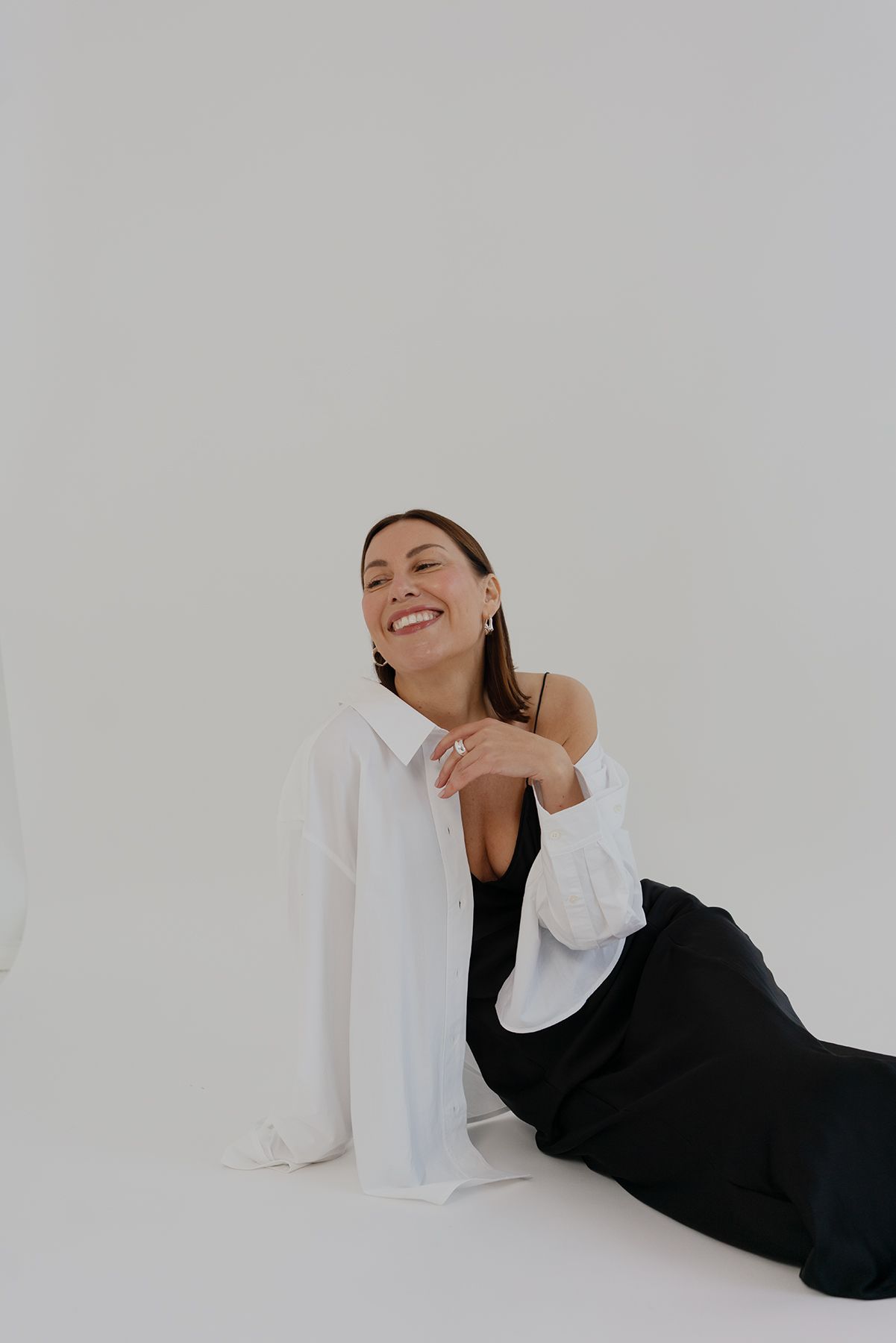 Fashion portrait in white studio setting with casual white and black outfit combination.