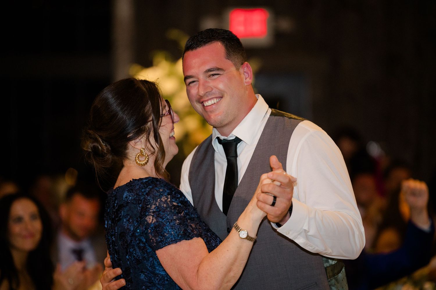 A couple shares a dance together at an evening wedding reception.