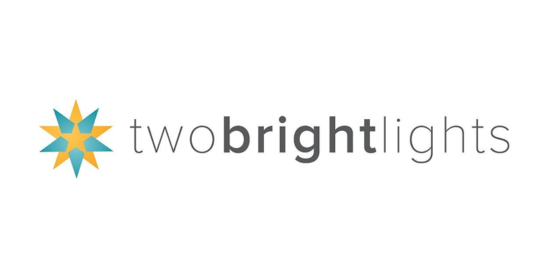 Two Bright Lights logo featuring a decorative star icon in teal and gold beside the company name in gray text.