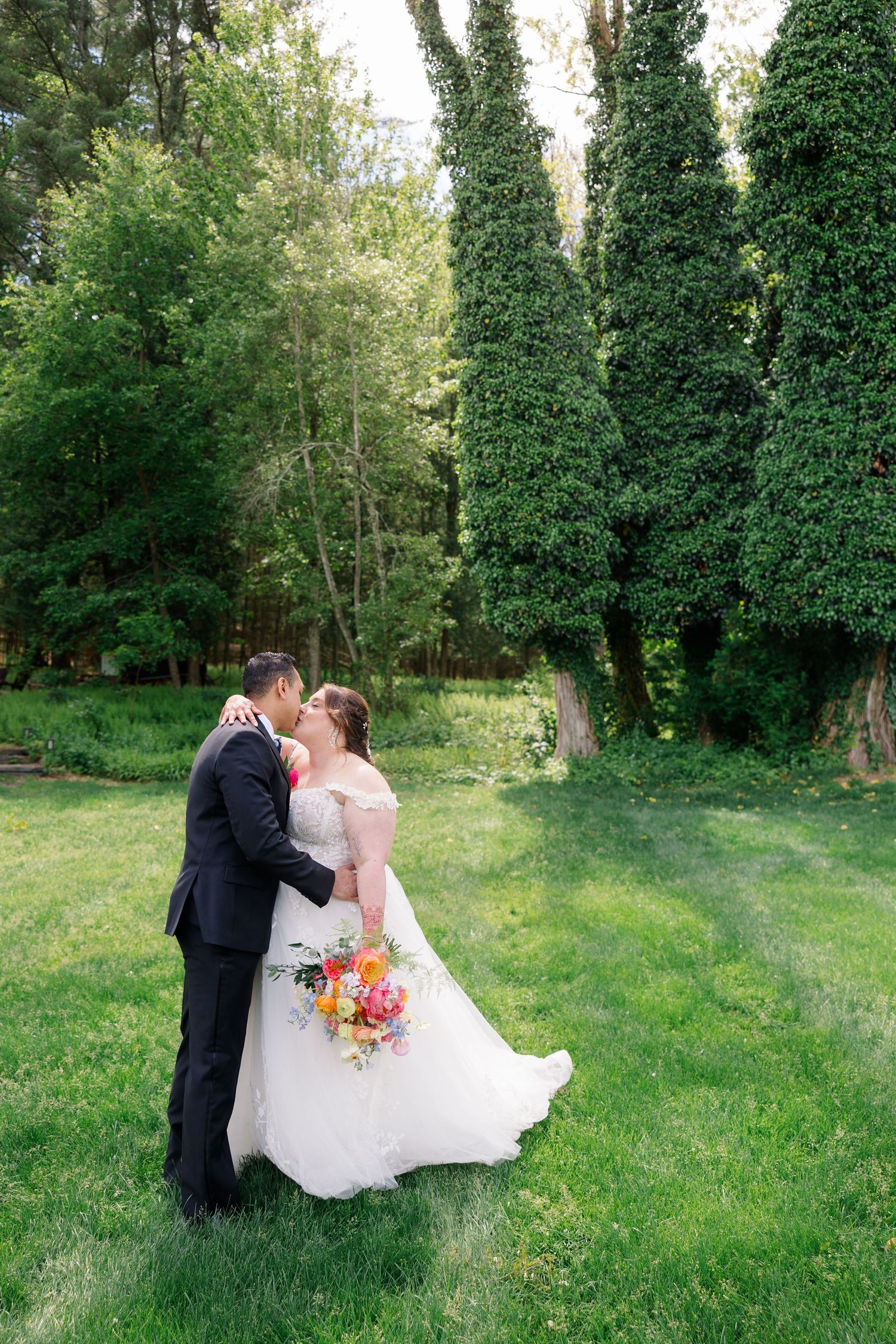 Romantic wedding photography in a lush green garden setting.