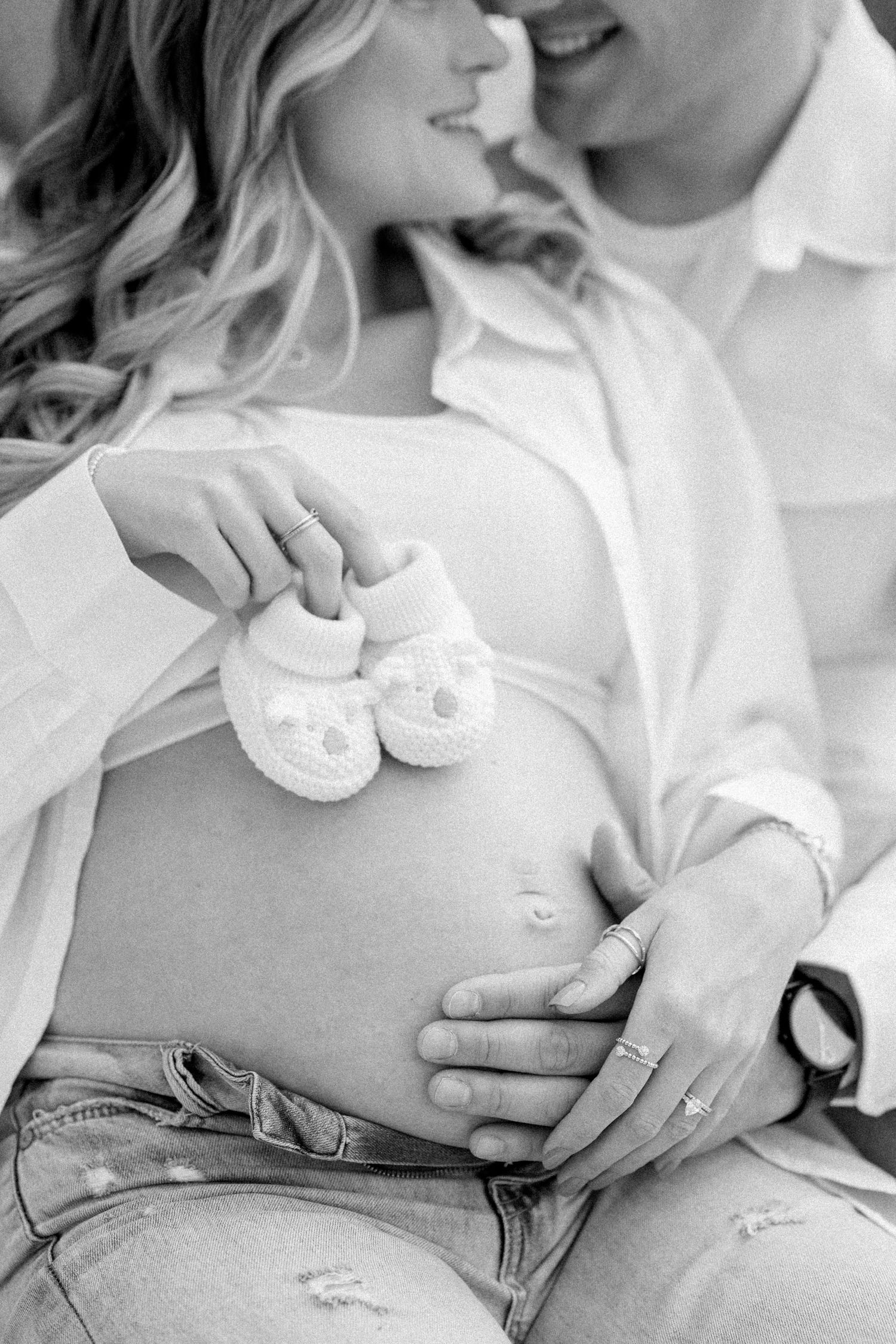 Series of intimate maternity photos focusing on a pregnant belly with gentle hand placements.