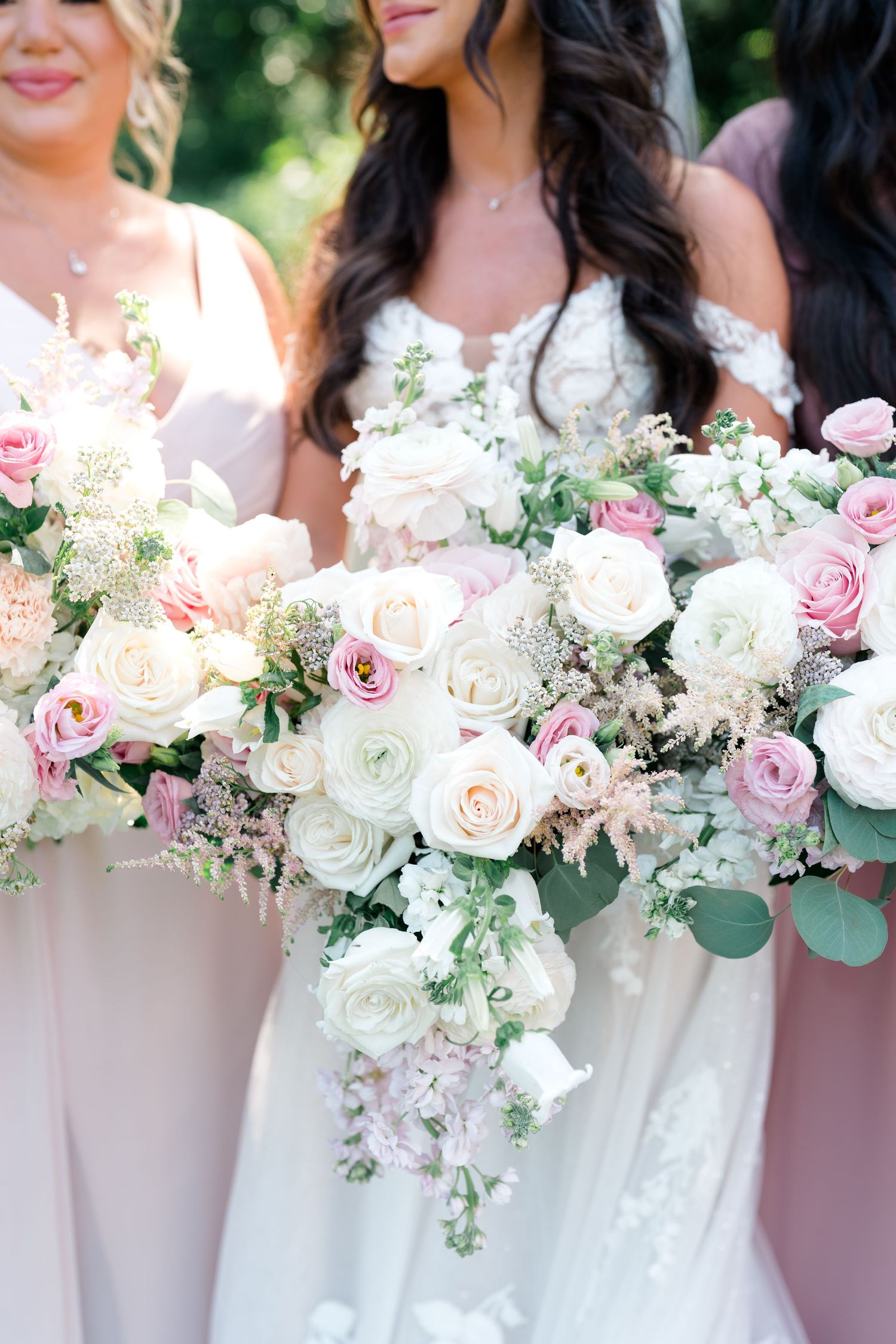 Elegant bridal bouquets featuring pink and white roses with eucalyptus greenery.