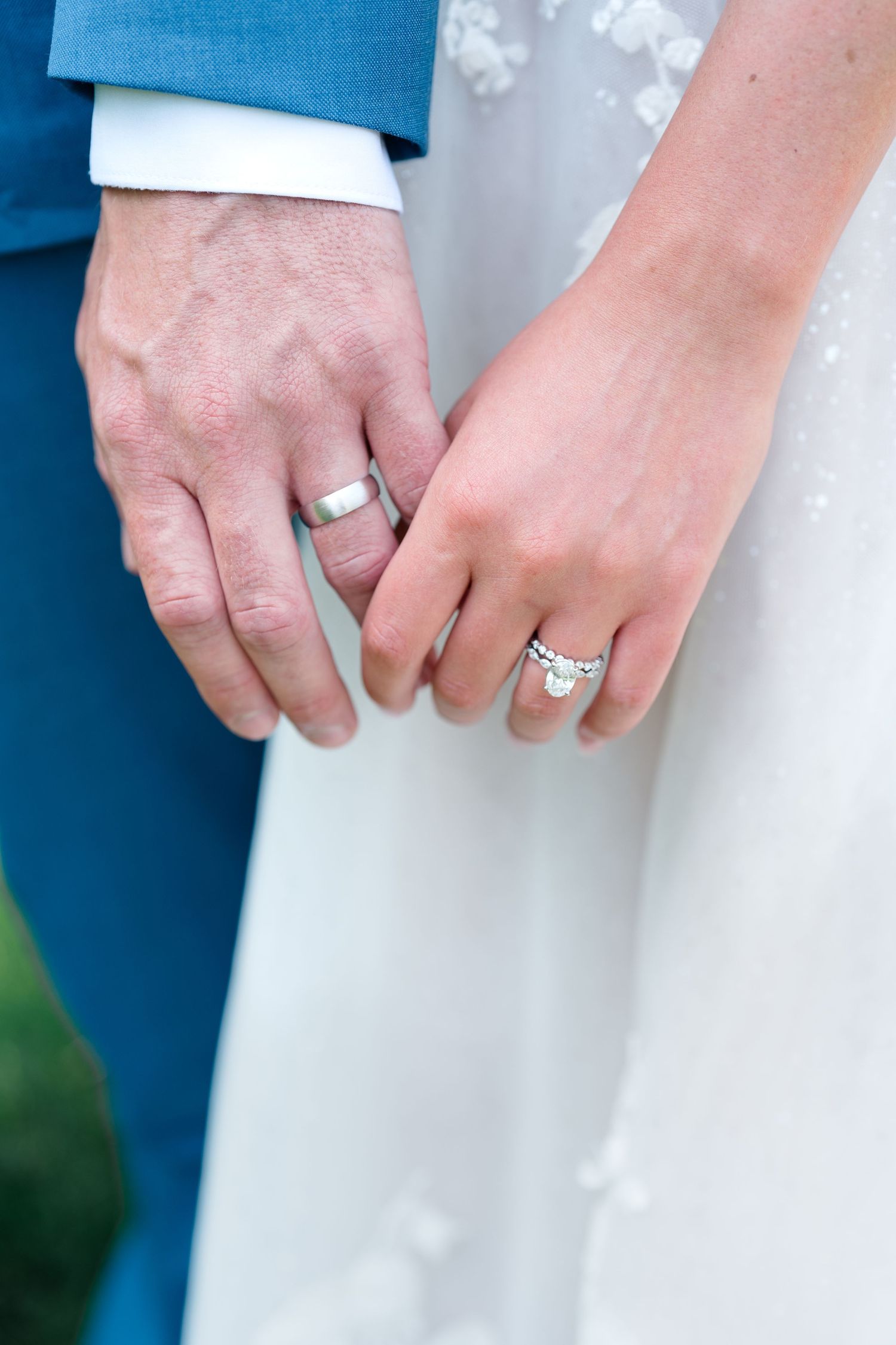 Wedding ring detail shots showing hands wearing elegant engagement rings and wedding bands.