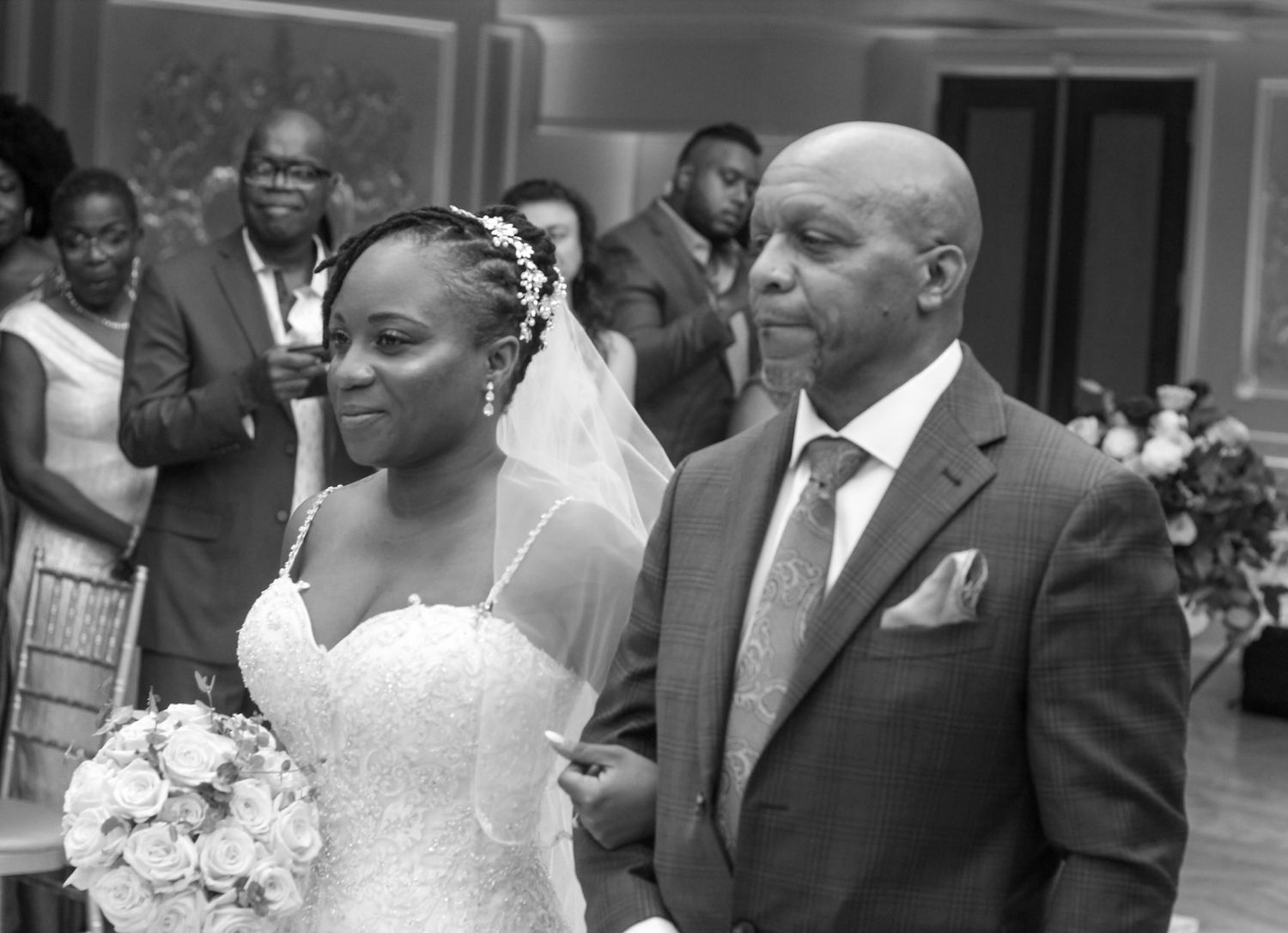 Black and white photo of wedding ceremony with classic architectural details.