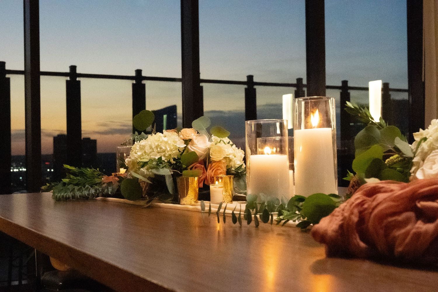 Scenic rooftop view of a city skyline at dusk with ambient lighting.